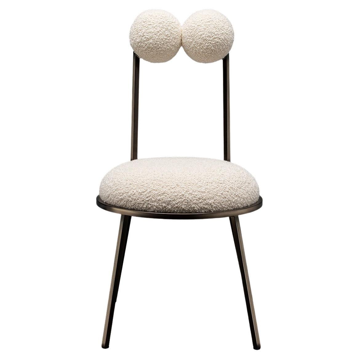 Trevor dining chair makes a perfect accompaniment for the tea room, its round spheres forming backrest and armrests, floating on thin metal rods, just like bonbons speared on cocktail sticks. Almost frog-like in its appearance, the chairs take the