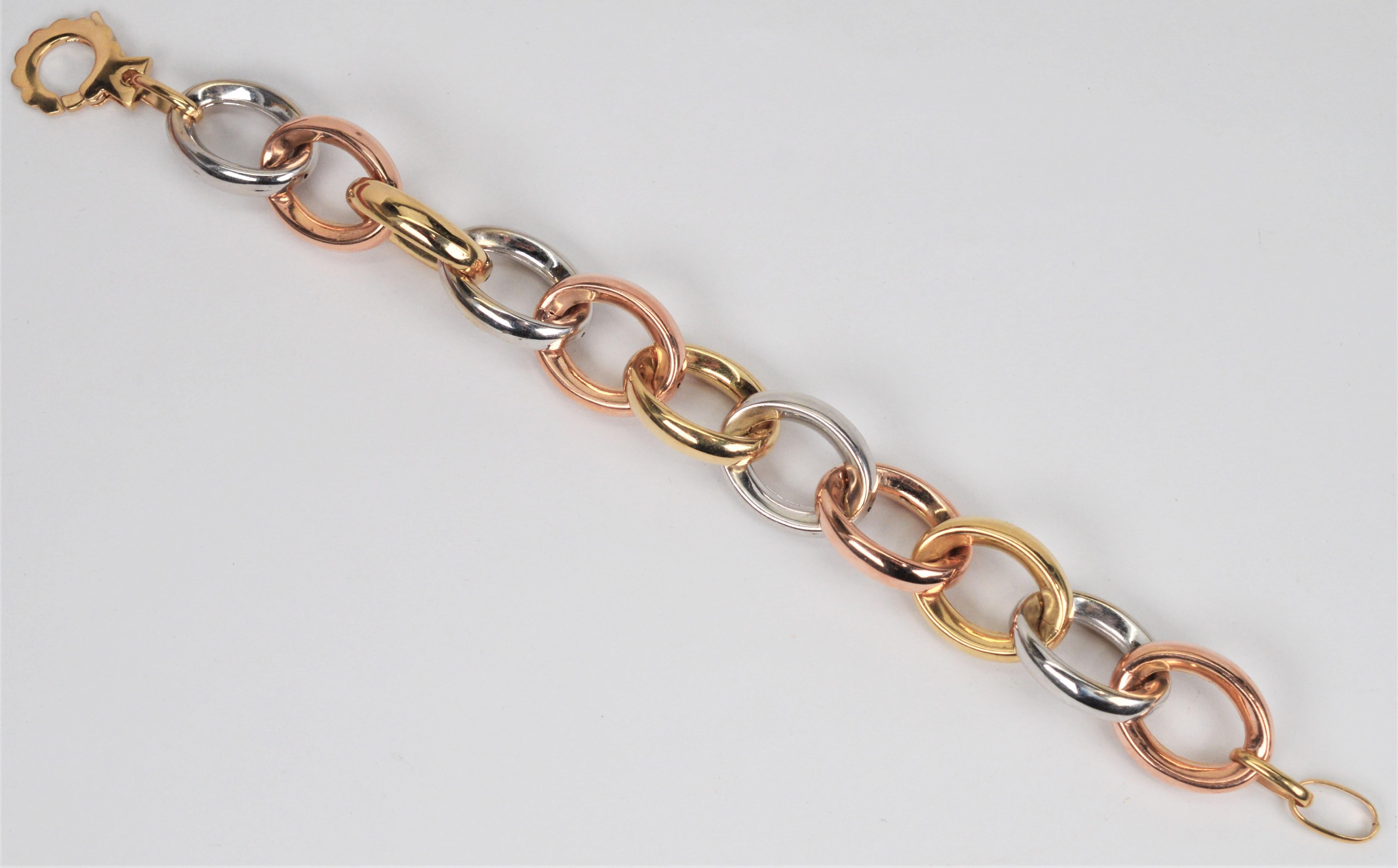 A bright and colorful triad of bold fourteen karat gold oval chain links create this classic retro style bracelet. Quality Italian made, interlocking hollow links of white, yellow and rose gold finished with a decorative, easy-on jumbo spring ring