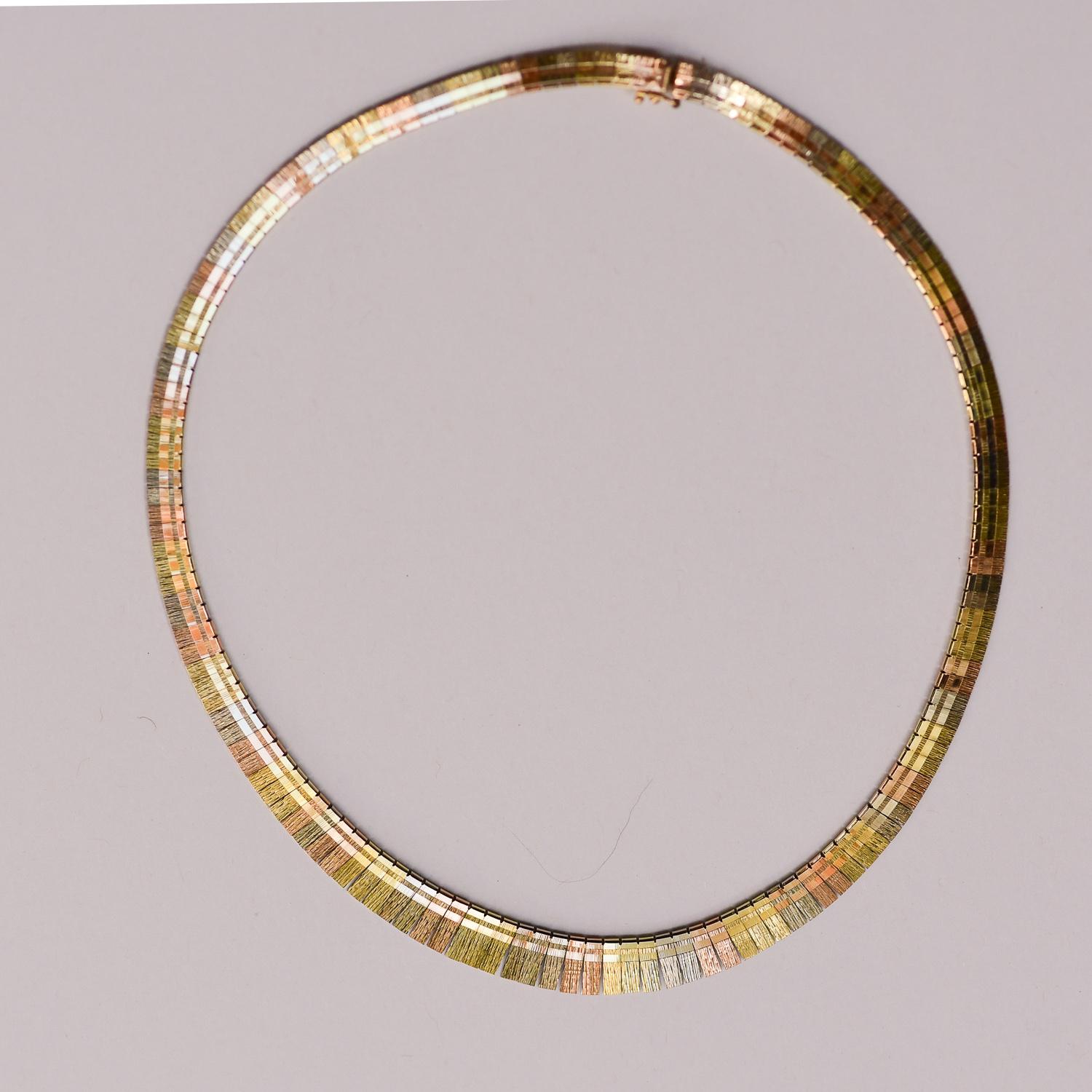 Elegant vintage Cleopatra style necklace in 14 karat yellow, white and rose gold. The necklace measures approximately 16 1/4 inches long. The width graduates to 7/16 inch. The weight is 24.9 grams. Excellent condition. 

#161053-1