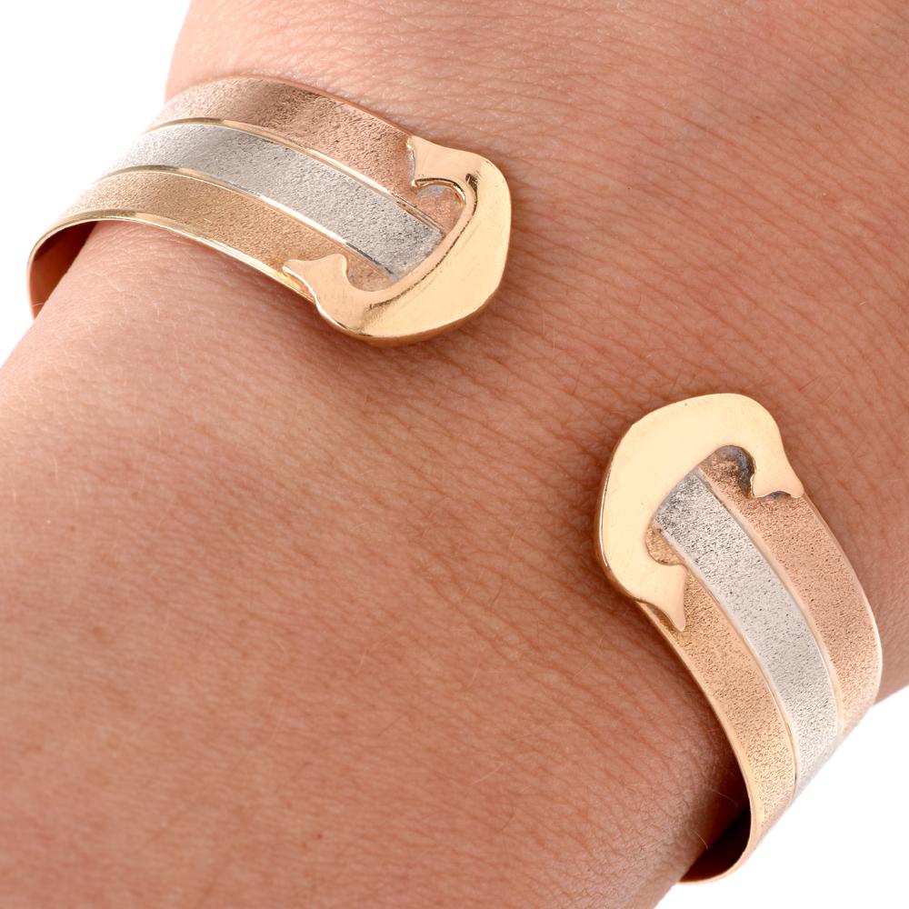 This comfortable chic unisex cuff bracelet of three adjacent stripes of 18 karat white, yellow, and rose gold, creating an intricate pattern. This alluring cuff bracelet weighs 20.9 grams and measures 6.75 inches around the wrist circumference,