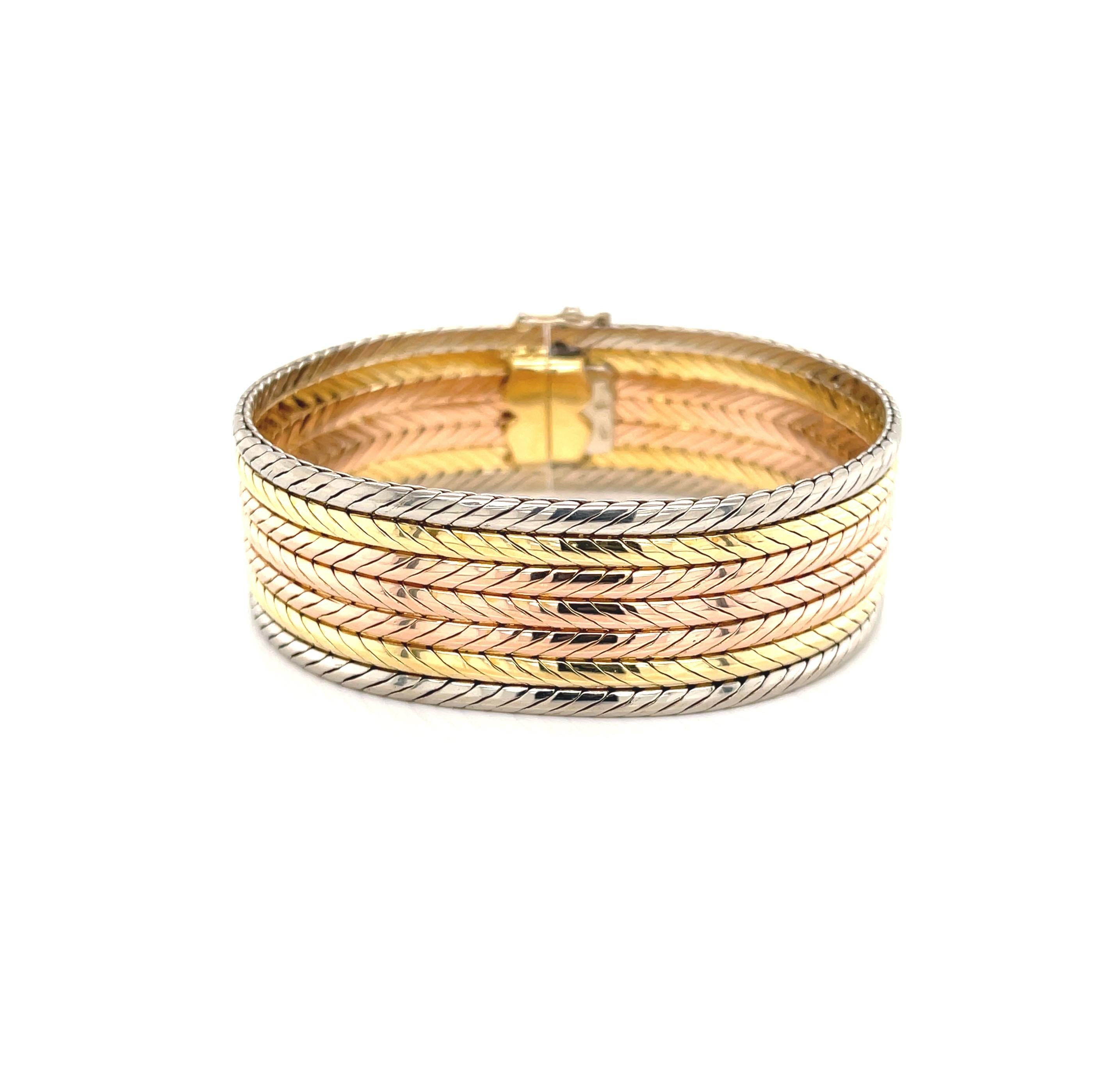Brilliant 18 karat rose, yellow and white gold in rounded serpentine chain are layered to create this captivatingly bold bracelet. Its colorful golden rainbow makes this piece so very versatile
 and the generous 3/4 inch width certainly makes a fine