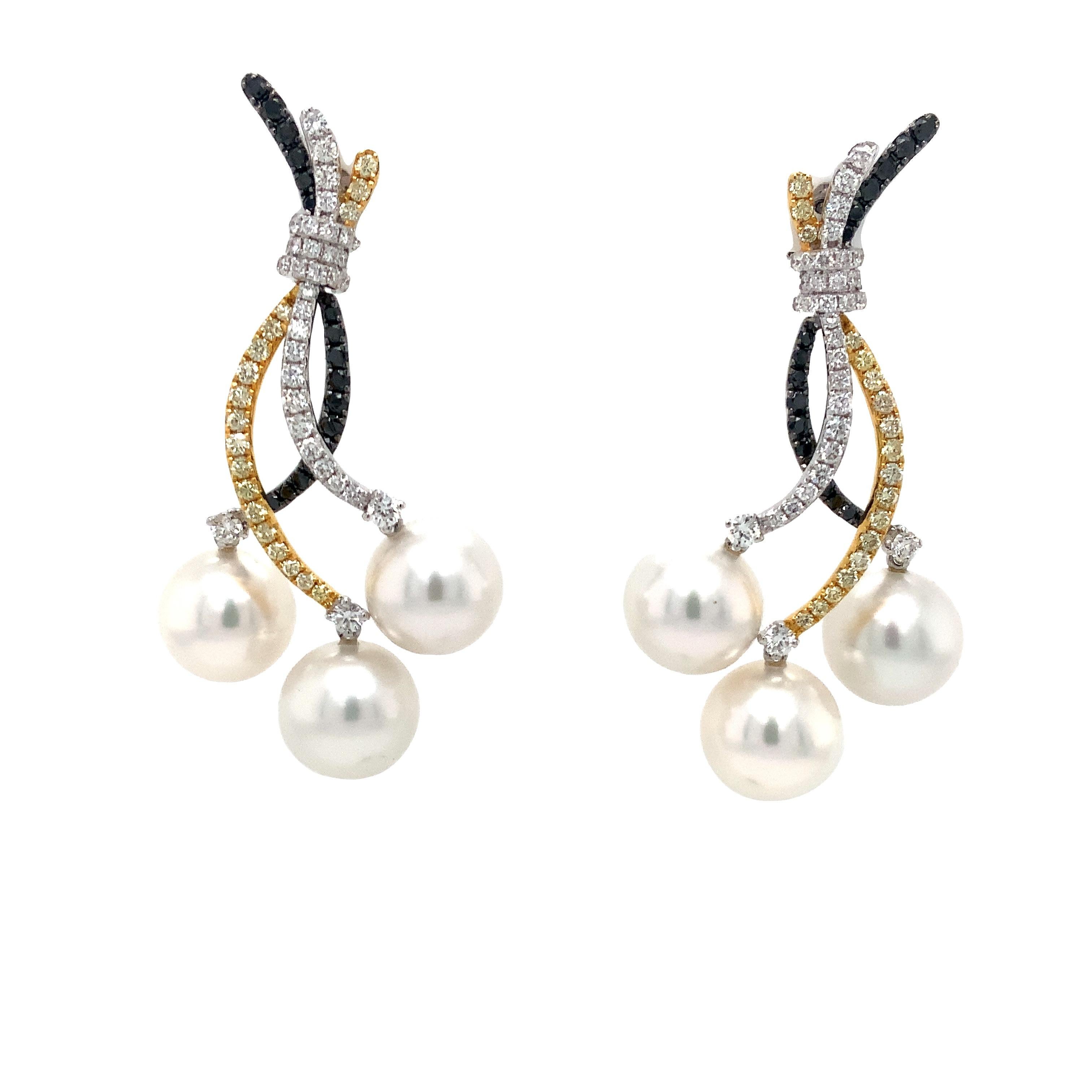 Tri-Color Diamond and Triple White South Sea Pearl Drop Earrings set in 18 kt Gold. Featuring Fancy Yellow Diamonds, White Diamonds, and Black Diamonds all intricately woven together, these earrings offer a dynamic look with each tapering branch