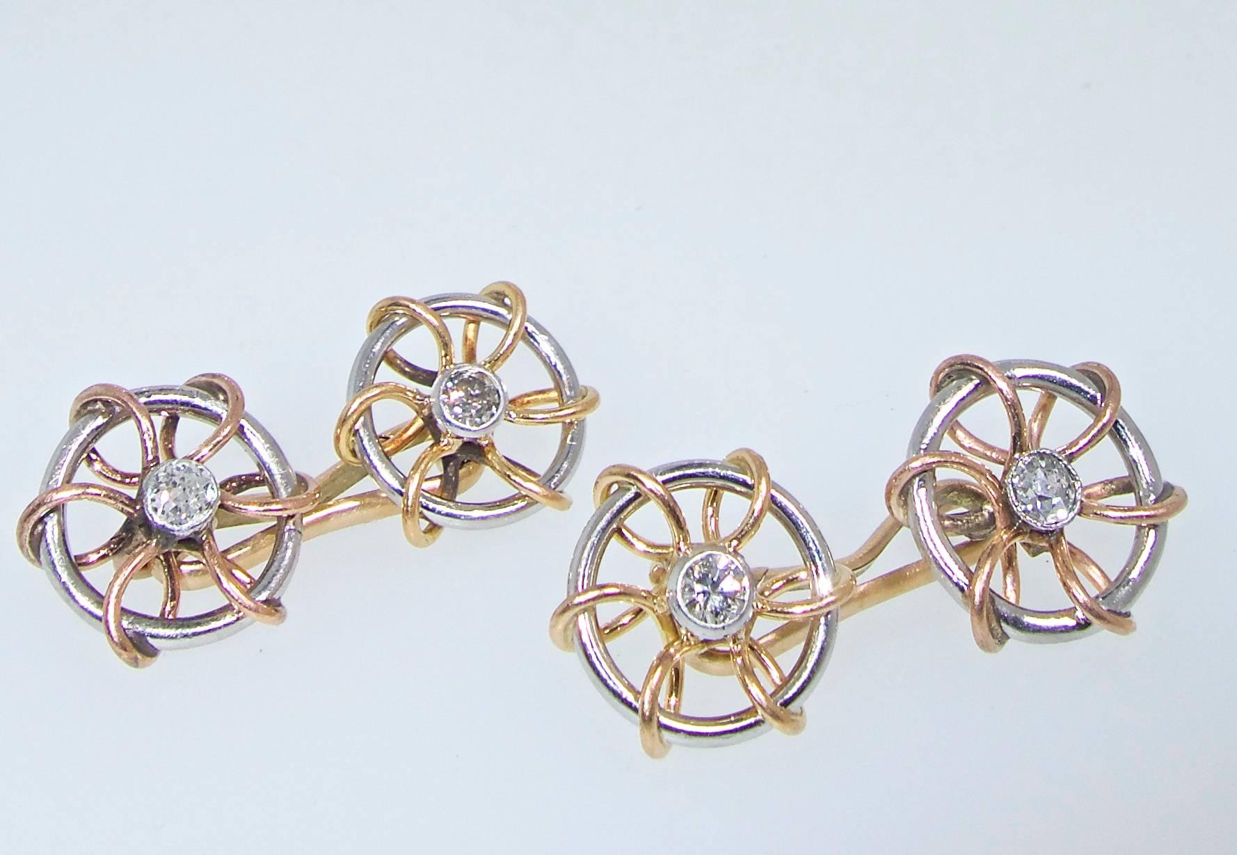 Centering a fine, white,  older cut,  diamond, TW .35 cts., approximately, these cufflinks are an usual circular design with pink, white and yellow gold.  With Austrian hallmarks, circa 1920.

Pierre/Famille, foremost in the acquisition and sale of