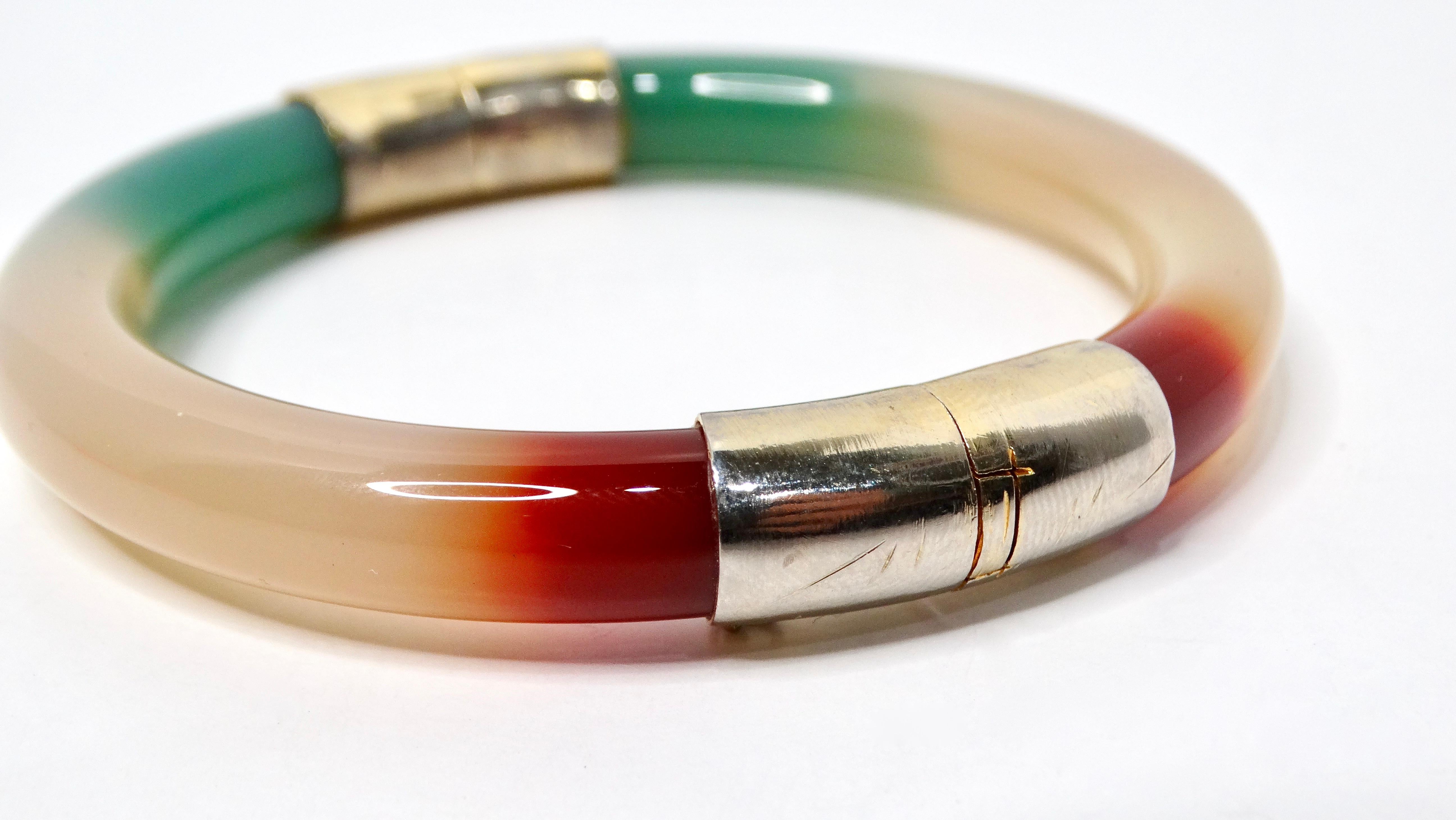 Introducing the exquisite Tri-Color Jade Hinged Bangle Bracelet, a stunning fusion of style and sophistication. Crafted from beautiful jade in three captivating hues—lush green, deep orange, and rich off-white—this bracelet offers a unique and