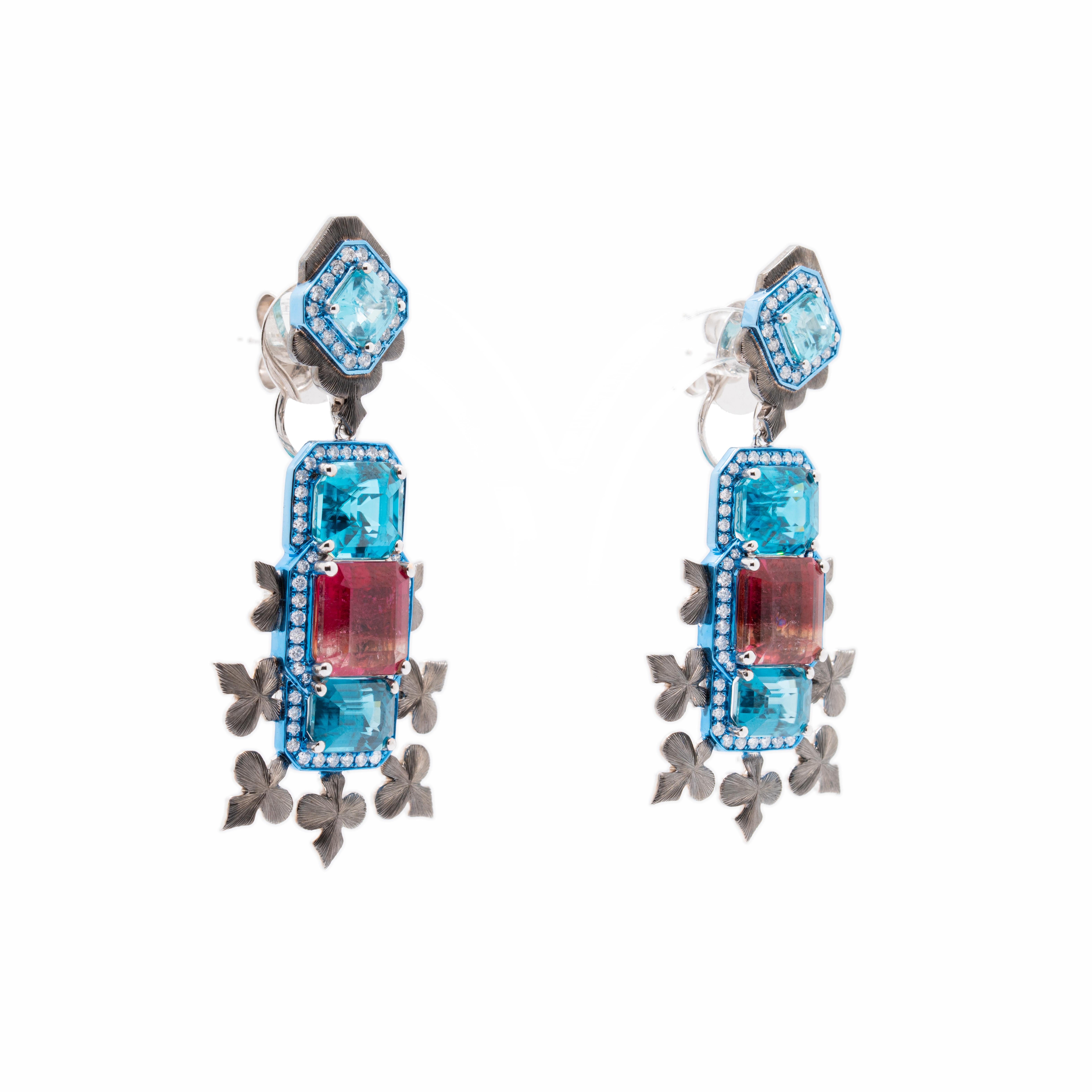 Questo moderno orecchino, disegnato da Austy Lee, trae ispirazione dall'eleganza dei fiocchi di neve. Il suo design è caratterizzato da tre pietre di zircone azzurro con taglio smeraldo, di dimensioni diverse, che evocano la bellezza del ghiaccio