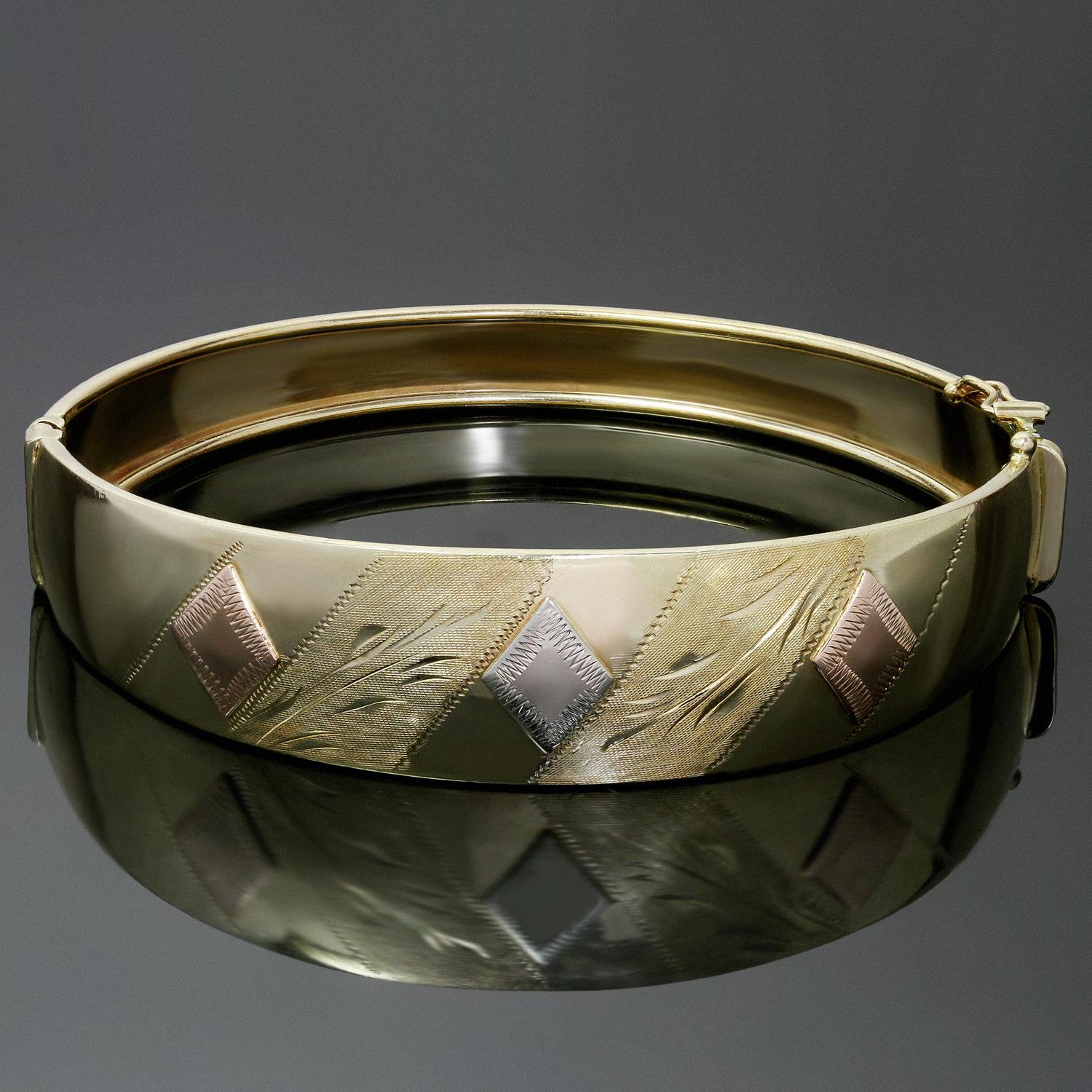 This elegant vintage wide bangle bracelet is crafted in 14k yellow gold and is accented with engraved details and geometric shapes in white and rose gold. Made in United States circa 1980s. Measurements: 0.62