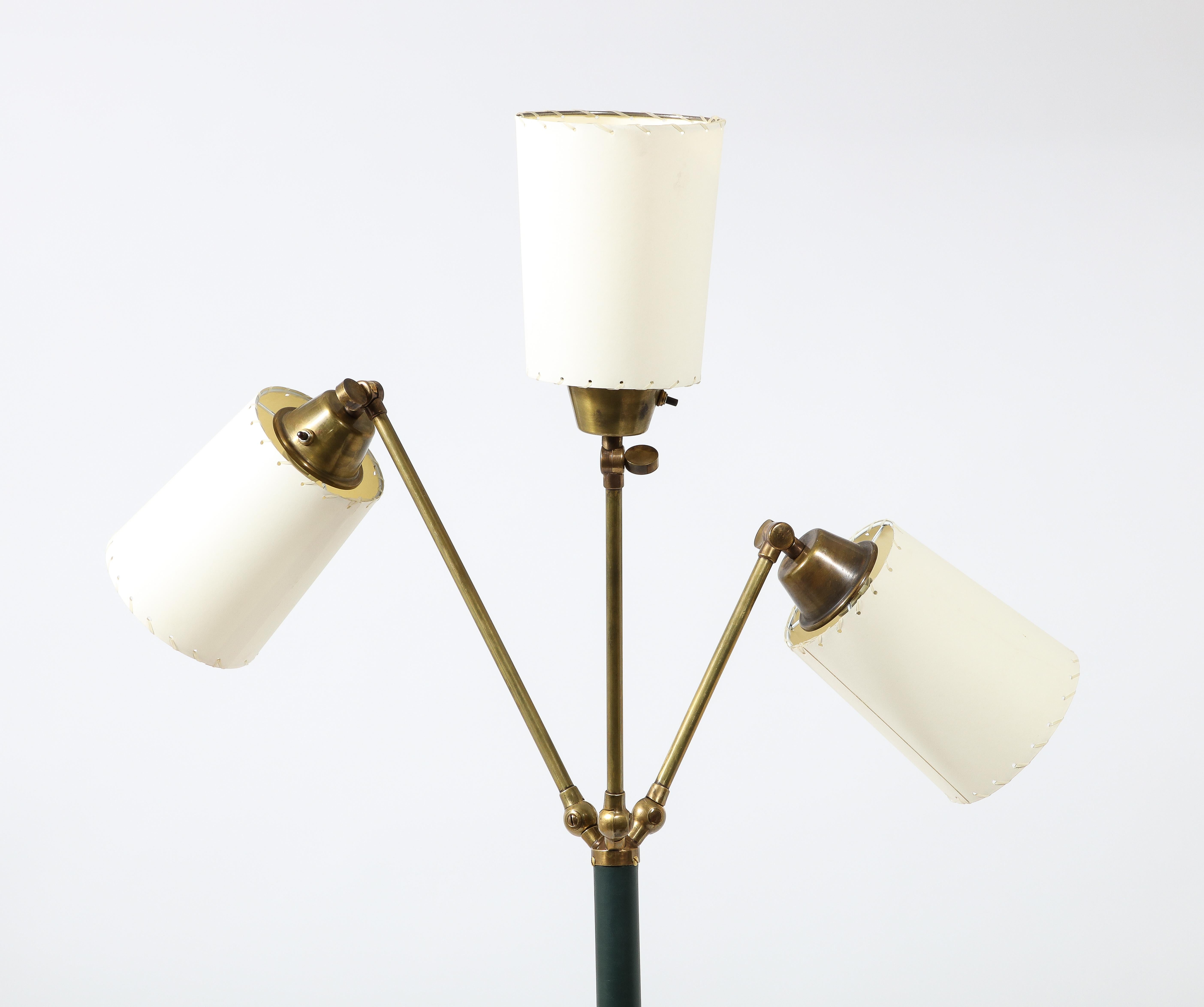 Fully Adjustable floor lamp by J Adnet with three arms, leather stitched stem, and hand-stitched shades. The height and diameter listed vary with arm position.
