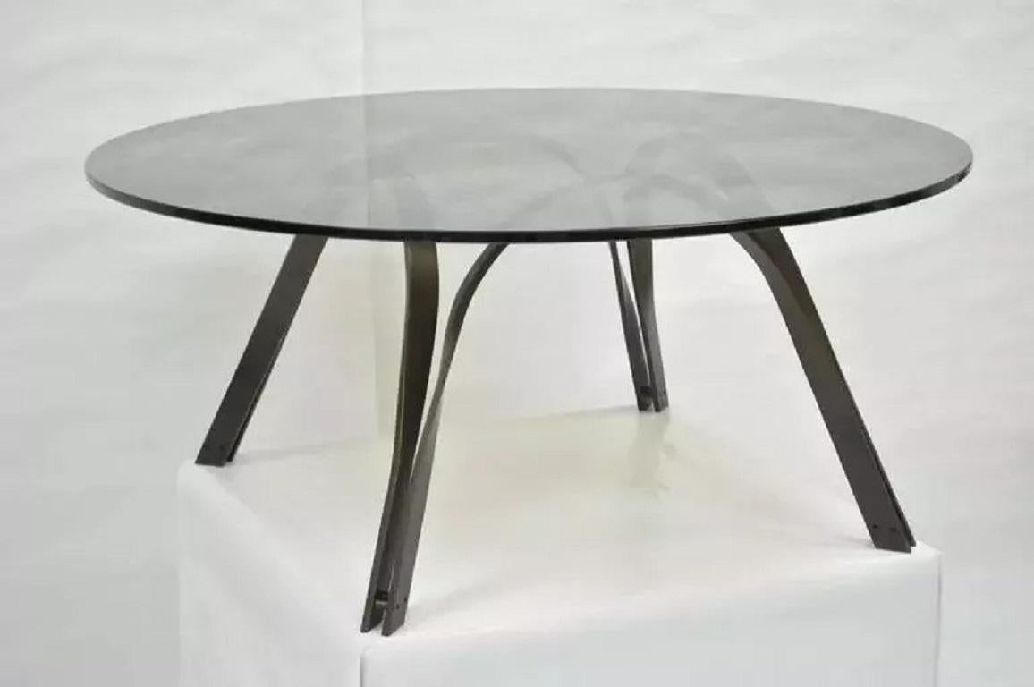 Tri-Mark Bronze Sculptural Round Glass Coffee Table After Roger Sprunger Dunbar. Item featured is made of  sculptural heavy steel and smoked round glass coffee table by Trimark in the manner of Roger Lee Sprunger for Dunbar . It also has a very rare