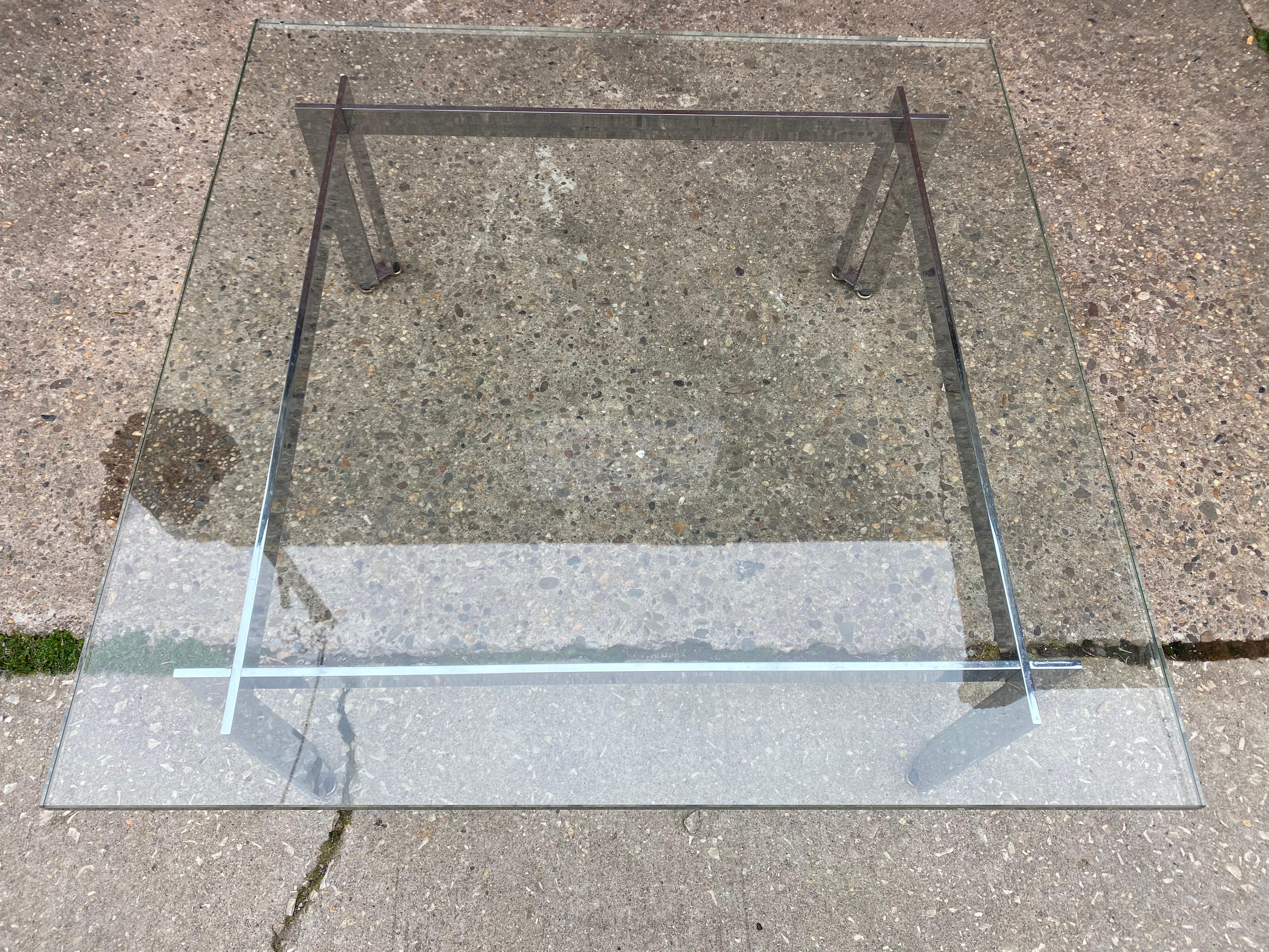 James Howell for Tri-Mark Chrome and Glass Coffee Table.  Elegant design with a corner crossing leg.  Very Sleek and Simple!  This design is sometimes seen as a dining table as well.  2 small chips to glass as seen in photos.