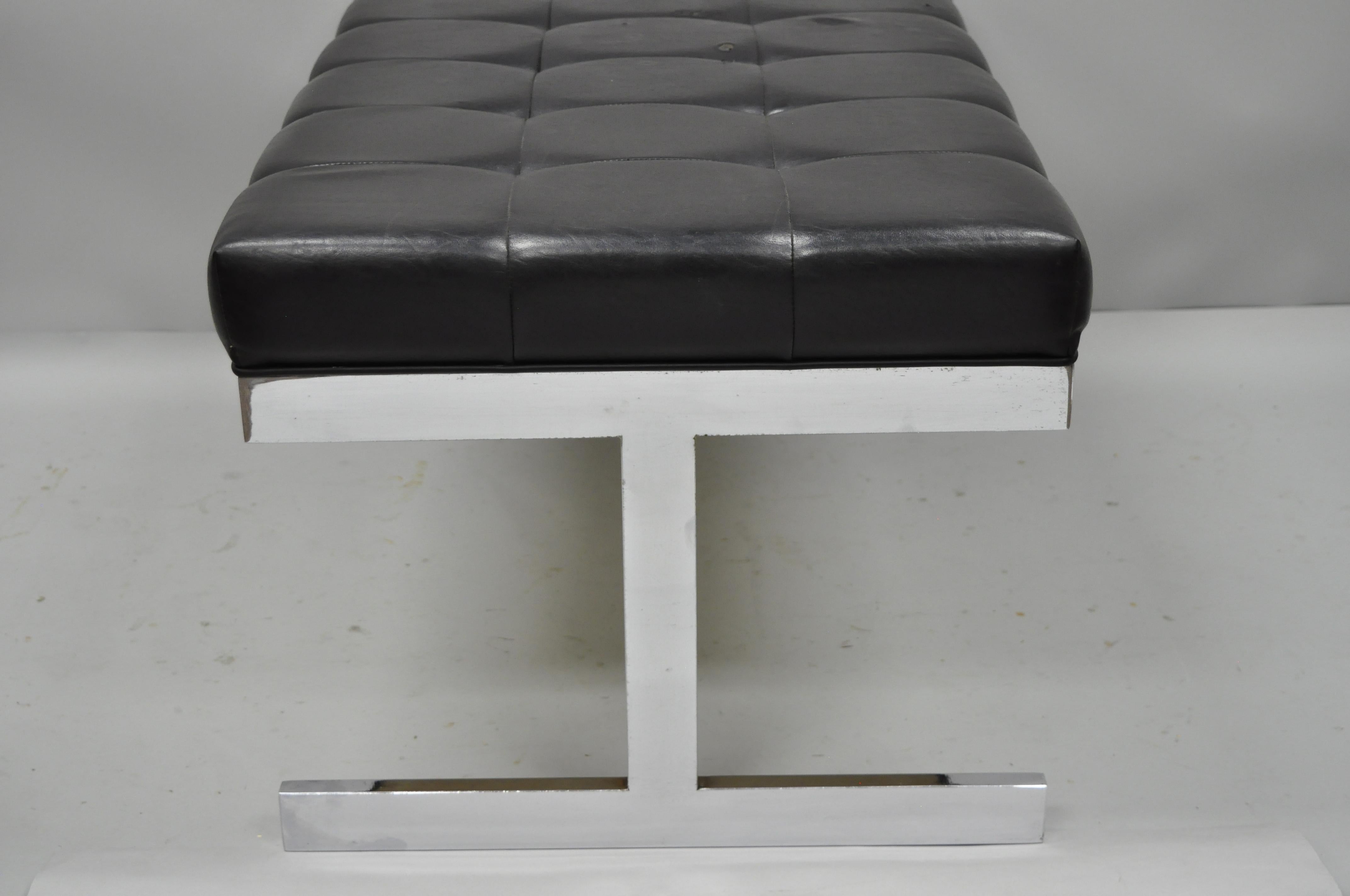 Tri-Mark design Milo Baughman style chrome and black vinyl tufted bench. Item features tufted black vinyl seat, chrome frame base, seamless joints, original label, clean Modernist lines, and great style and form, circa 1960. Measurements: 19