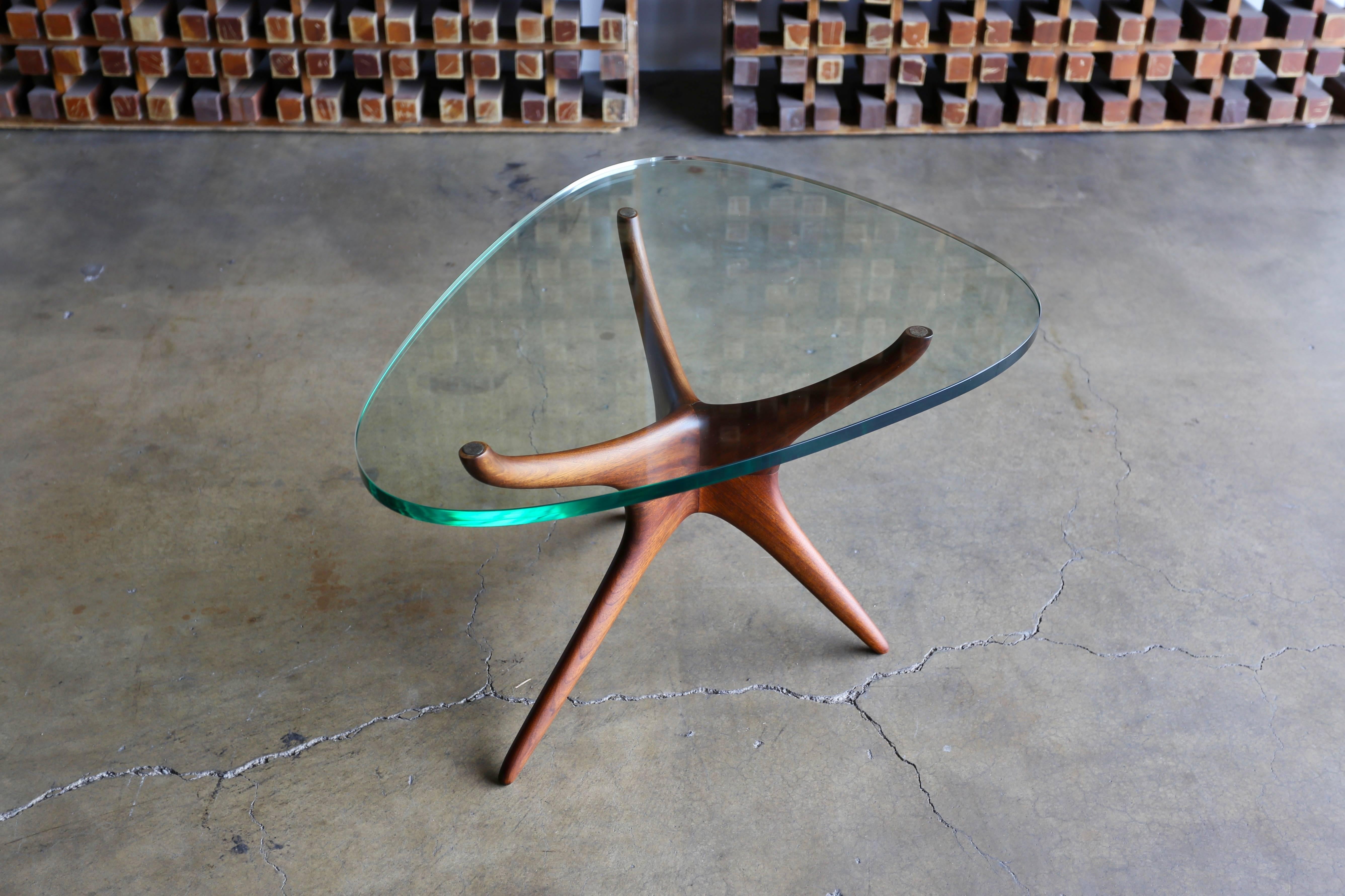 Tri-symmetric glass and walnut occasional table by Vladimir Kagan for Kagan-Dreyfuss, Inc.