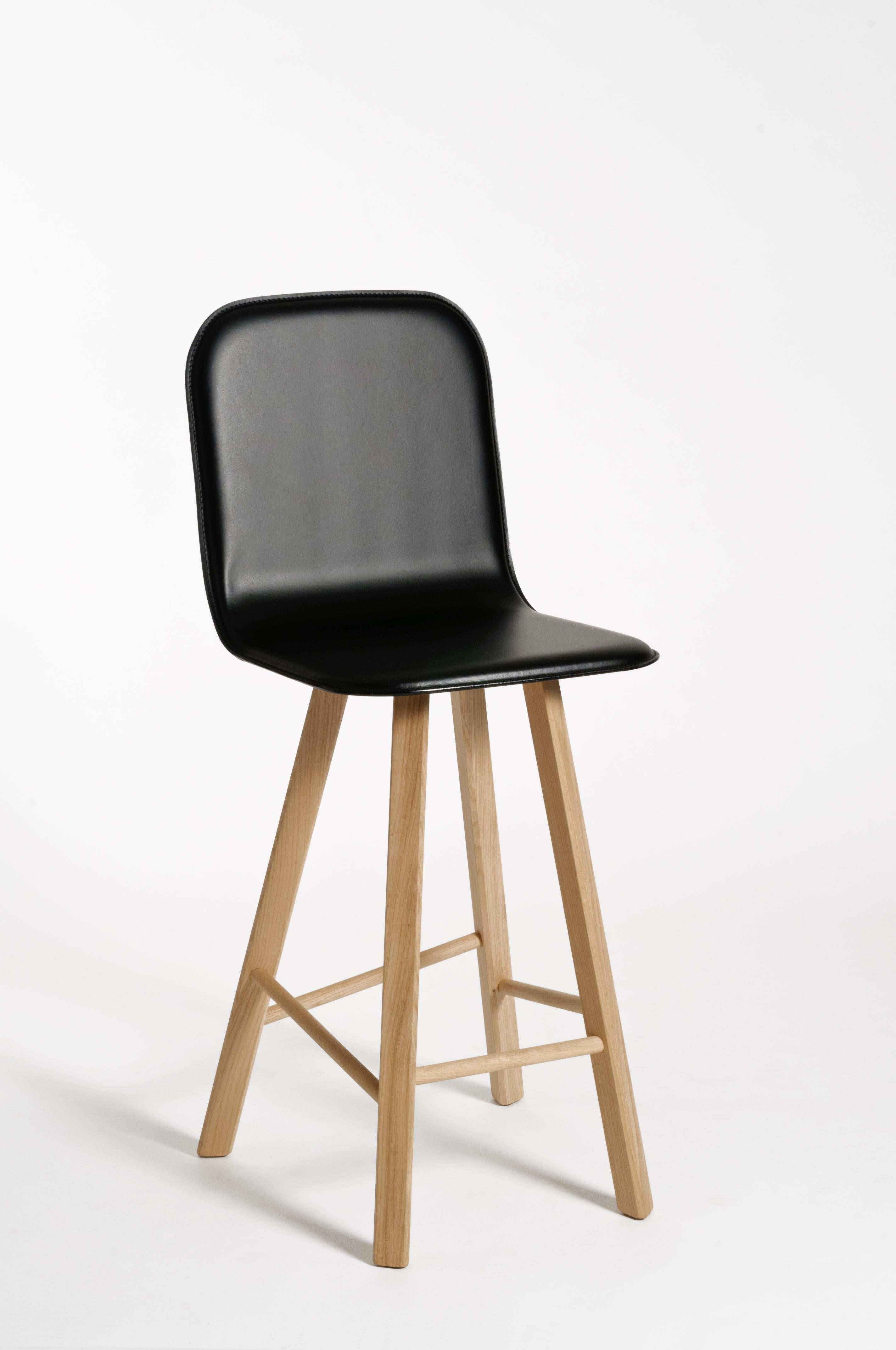Essential and elegant stool with a bent plywood shell and four iconic legs with triangular shape in solid oak, joined by transversal wooden bars. The seat can have High Back as listed, for a very comfortable long time seating, or Low Back as a