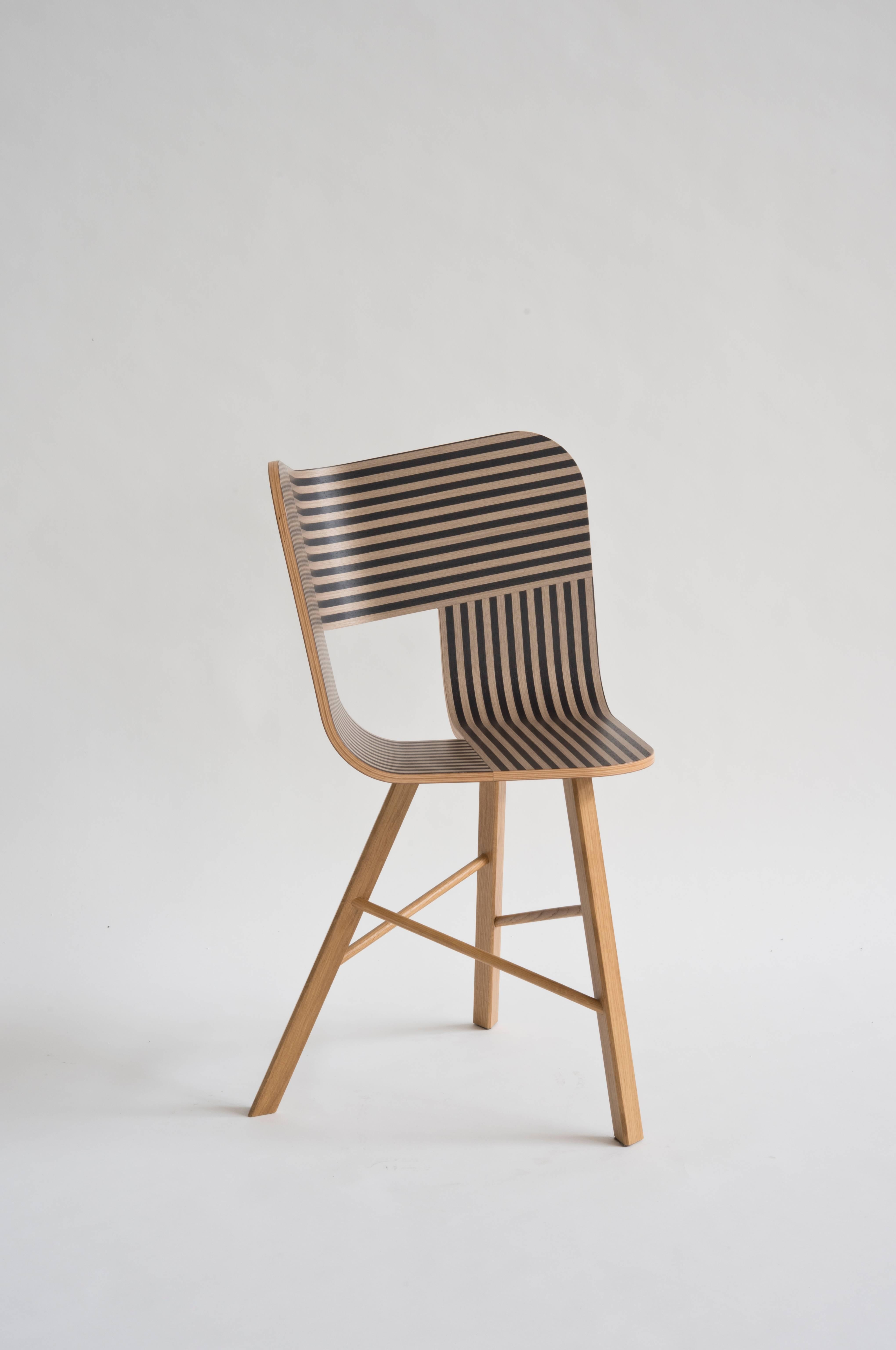 Tria wood chair is the icon of our collection. It's a table chair, but many people use it as a sculpture for the Ambience, in an entrance, a bedroom or in a living room. It recalls the impossible forms of Dutch graphic artist and engraver Maurits