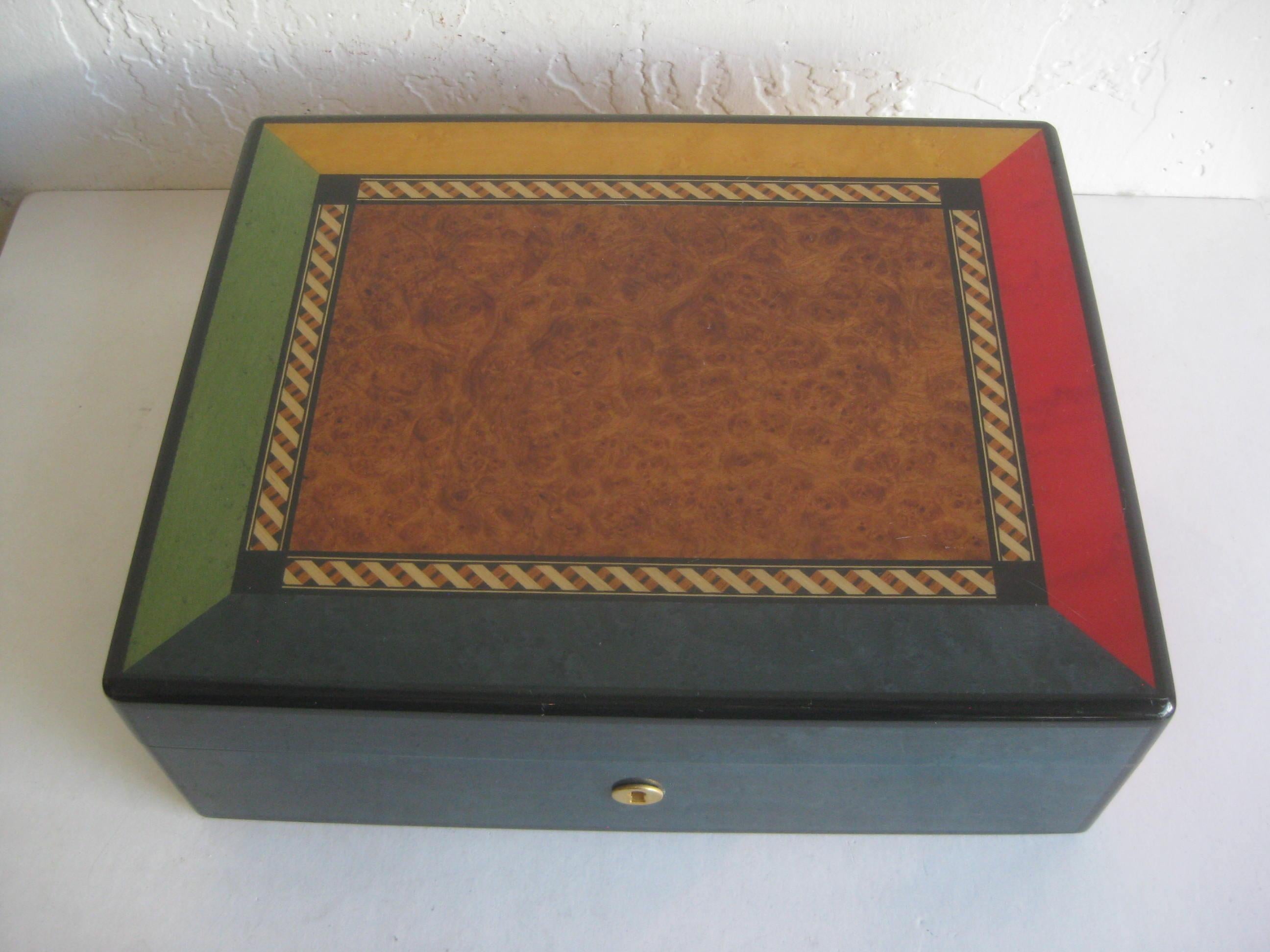 Elegant Triade French cigar tobacco humidor box. Beautiful color inlay with burl wood in the center of the top. Clear lacquer finish. The box is made of solid mahogany. The key is missing. In very nice shape with some minor surface scratches and