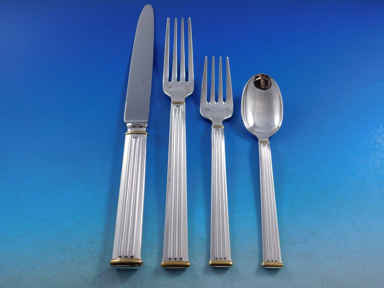 Modern clean lines in a Classic column motif makes this pattern, Triade, forever timeless. 
Monumental Dinner Size Triade Gold Accent by Christofle France Silverplated Flatware set - 162 pieces. This set includes:

12 Dinner Knives, 9 3/4