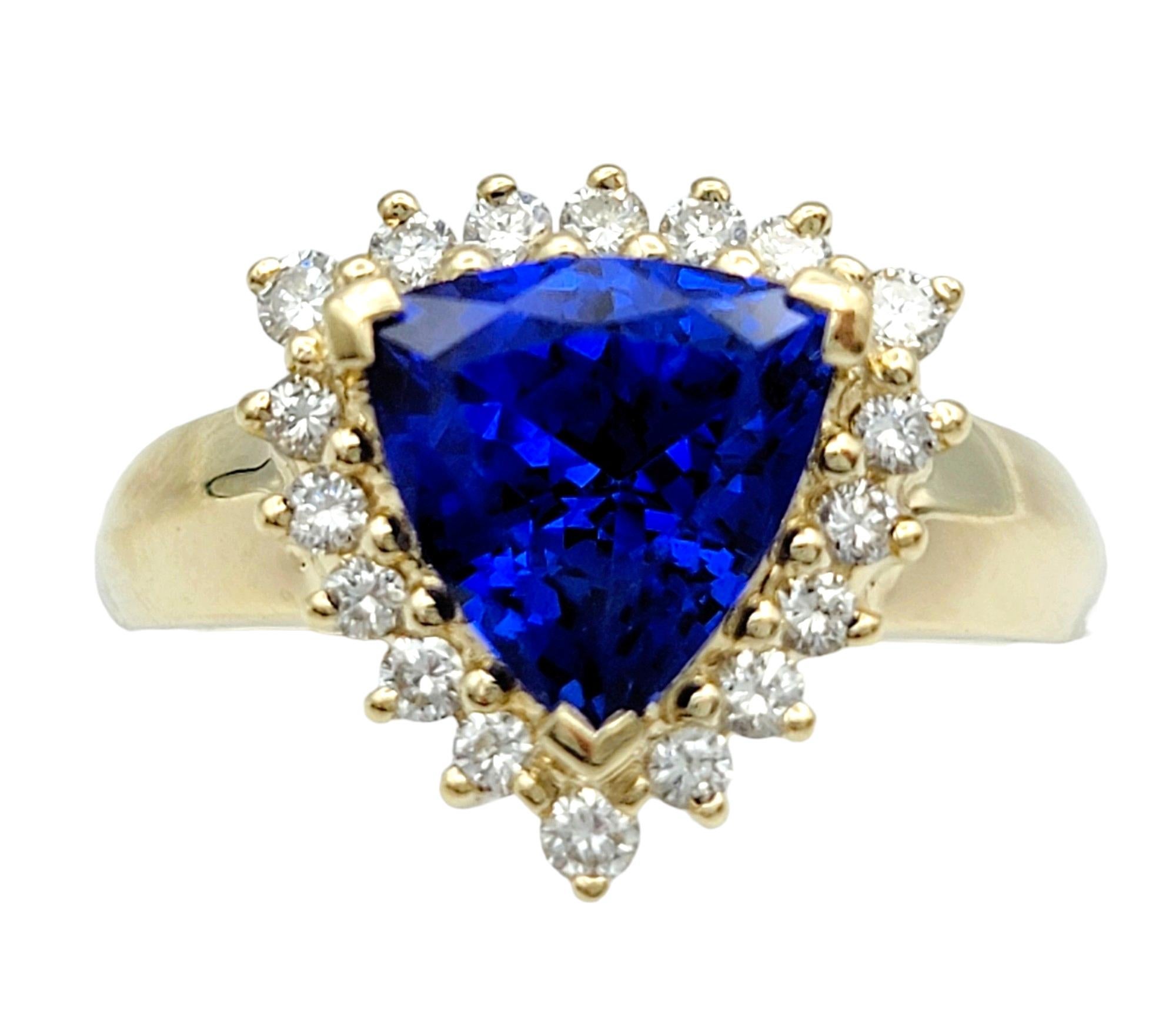 Ring Size: 6.5

This striking triangular blue tanzanite ring, exquisitely set in 14 karat yellow gold, is a work of art. The centerpiece of this ring is a vibrant triangular tanzanite, its deep blue hues captivating and alluring. Surrounding the