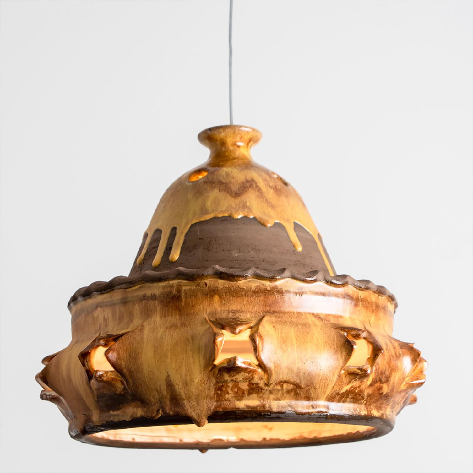Stunning round hanging lamp with an pie-like shape and design, made with rich terra colored brown ceramics, manufactured in the 1970s in Denmark. We also have a multitude of unique colored ceramic light sets and arrangements, all available on our