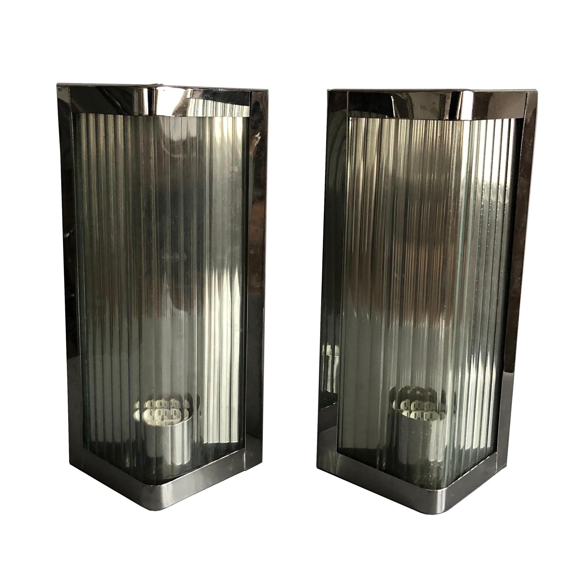 Custom made sconces from a ski resort in South Tirol, Italy.
Wall lights framed with polished stainless steel and reeded glass.
Reeded glass reduces glare to the eyes.
The sconces are supplied with European E27 light bulb fitting which is
