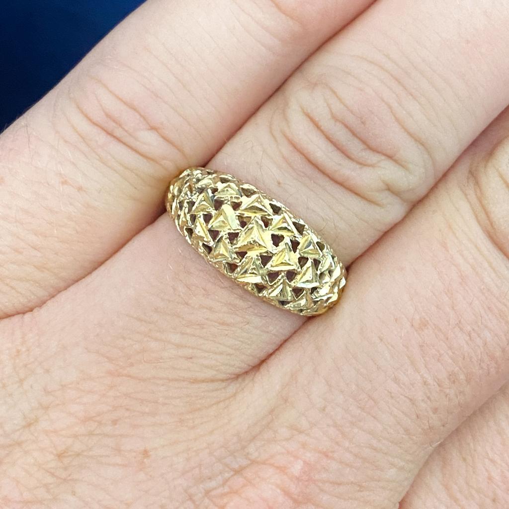 This ring is a unique all gold design with lots of beautiful triangle cuts and diamond-cut accents to add sparkle. The domed design is strong and comfortable with gorgeous details. The center top of the ring measures 8.75 mm wide and tapers to 3 mm