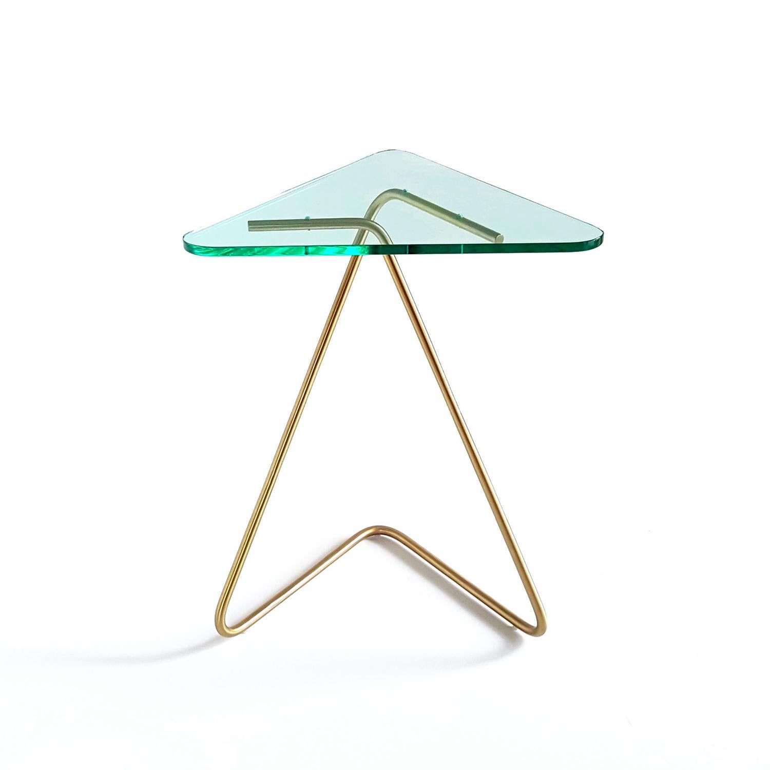 The triangle side table by Rita Kettaneh 
Dimensions: The base: brushed stainless steel plated with brass
 optionally plated with copper or brass
 The top: acrylic
Materials: H 49.5 x W 41 x D 9.5 cm
Weight: 2.6 Kg

Colors and