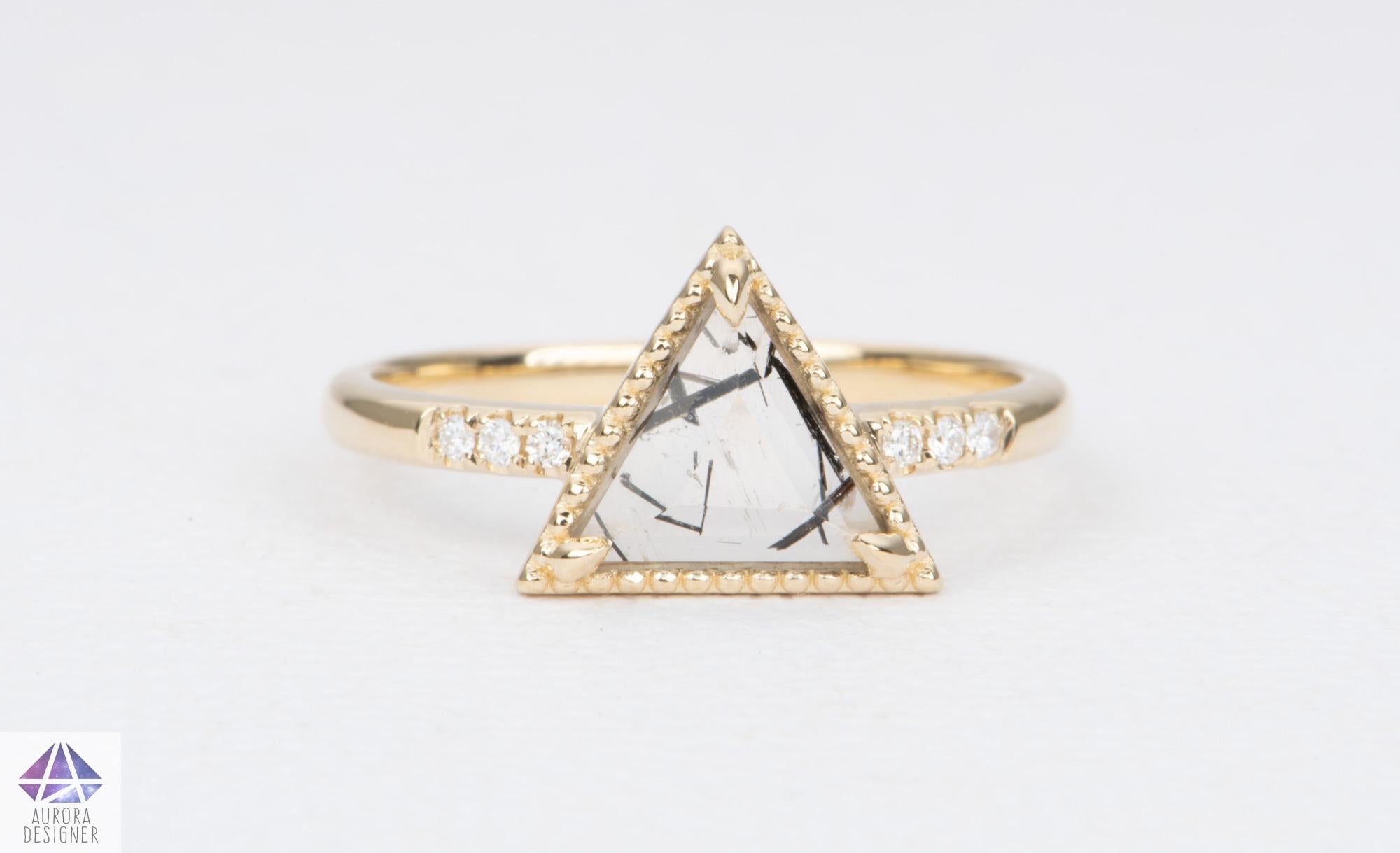 ♥ Geometrical tourmalated quartz stone with naturally occurring black striations sits centered between three pave diamonds on each side.
♥ Three modern claw prongs secure the triangular stone, which is surrounded by an ornate milgrain edge.

♥  US