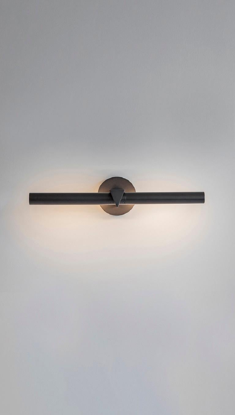 Triangle wall light by Square in Circle
Dimensions: D19 x W50 x H50 cm
Materials: dark bronze finish
Other finishes available.

Discreet by design, our slim picture light is inspired by classic museum fixtures. The light tube is rotatable from