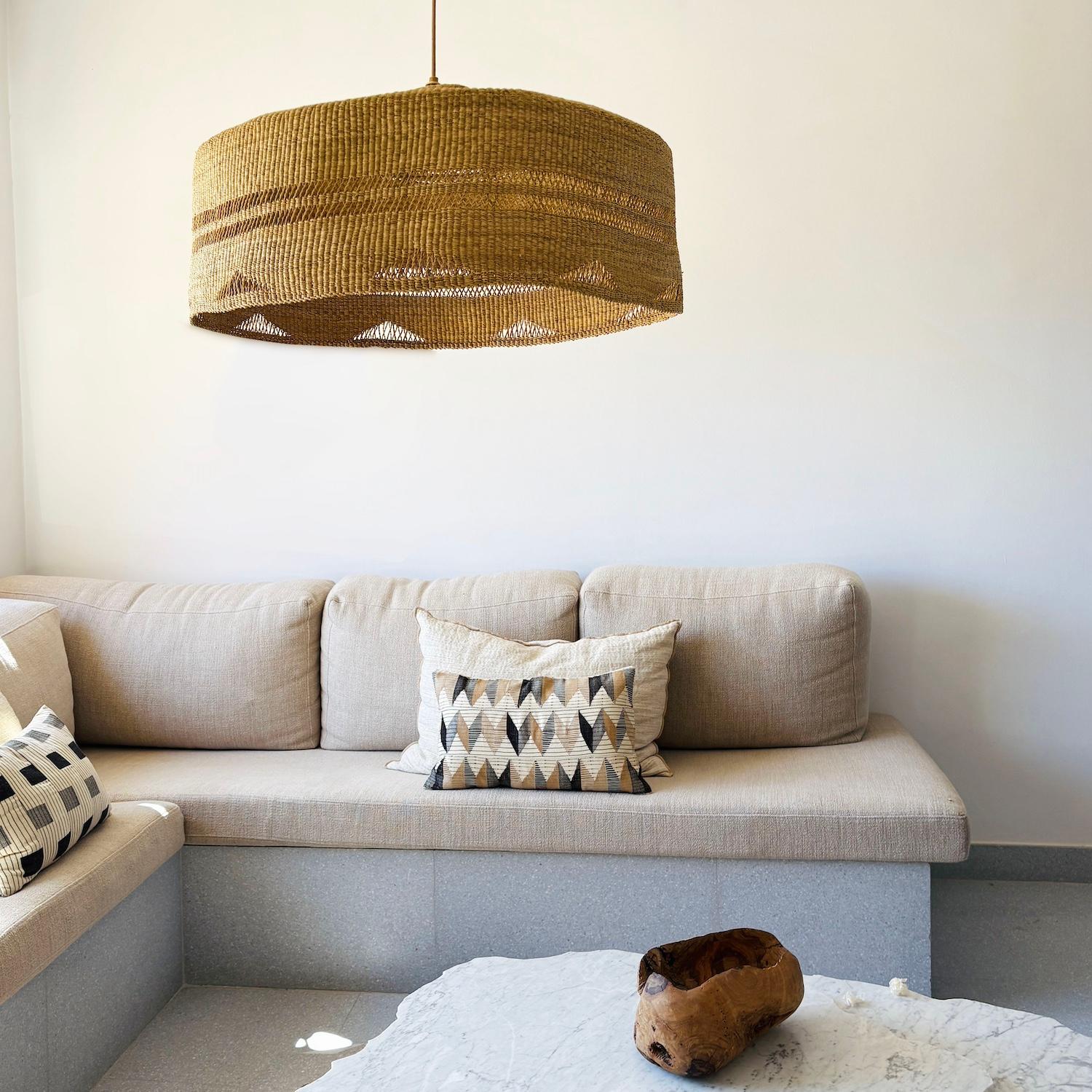 Oversized woven straw pendant lamp with a bold triangular weave pattern. This lamp provides soft, ambient light and natural texture, ideal for statement dining spaces, living areas, or hospitality interiors. Artisan-made in Ghana and finished in