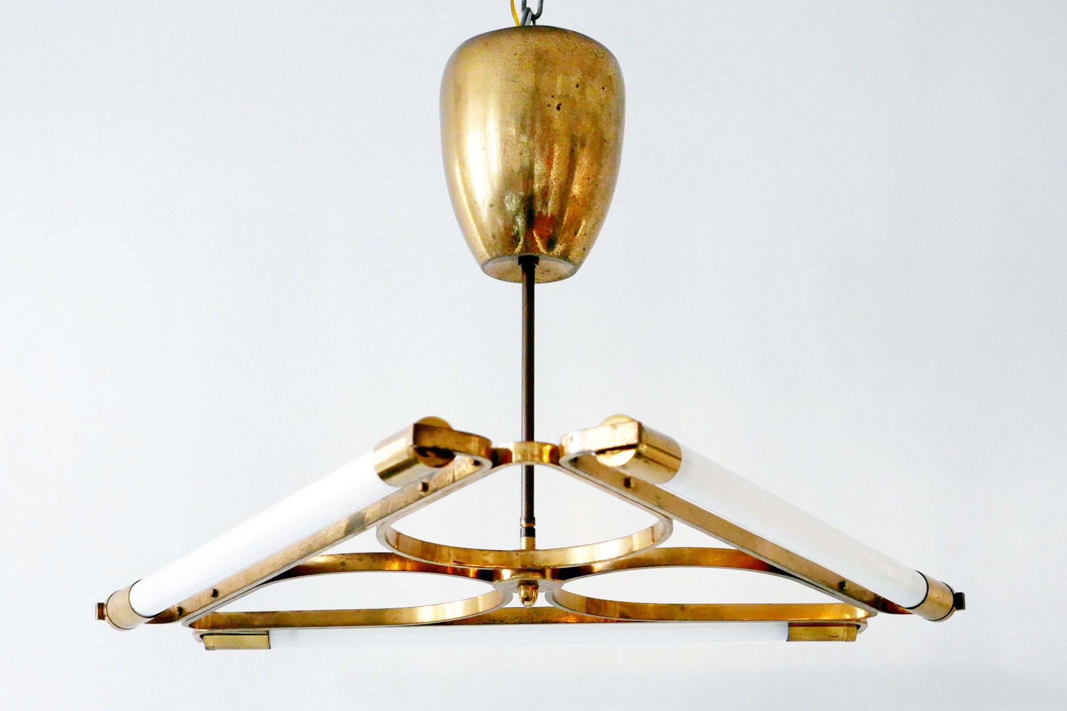 Exceptional and elegant Bauhaus triangular brass chandelier or pendant lamp with three fluorescent tubes. Designed and manufactured in 1930s, Germany. Extremely rare design.

Executed in brass, the chandelier needs 3 x fluorescent tubes. It works