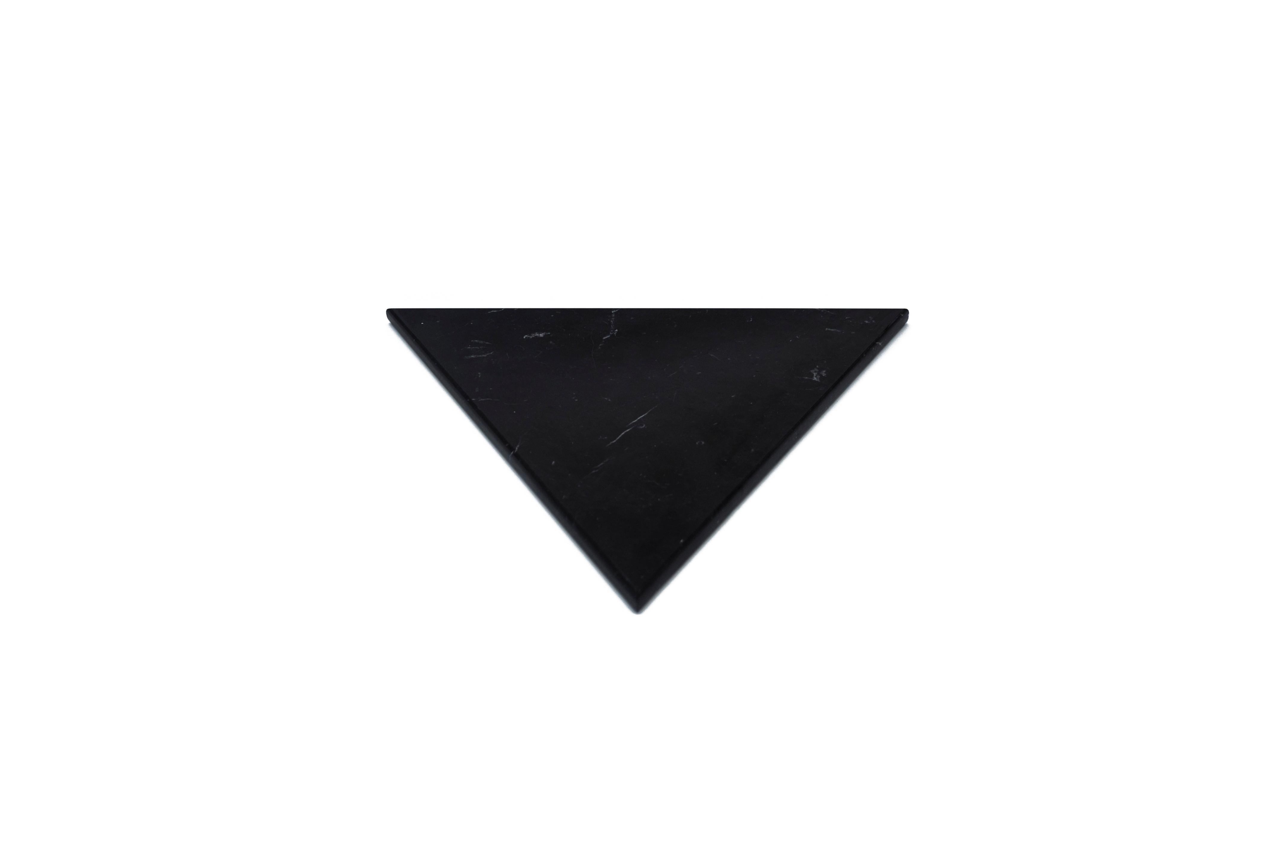 Black Marquina marble cutting board and serving tray with triangular shape and cork underneath. Each piece is in a way unique (every marble block is different in veins and shades) and handmade by Italian artisans specialized over generations in