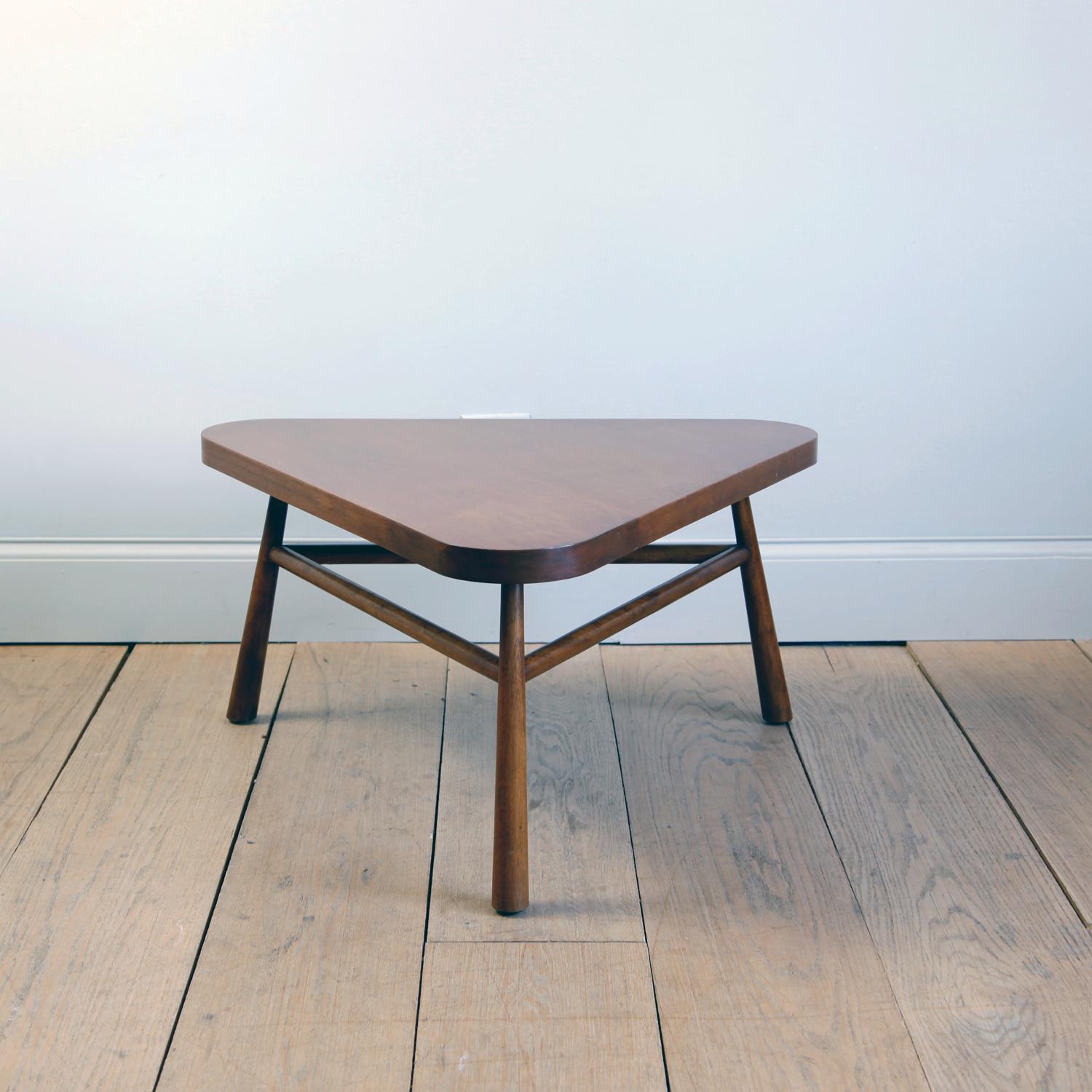 An Asian-inspired design. The three legs subtly flare in diameter, and are splayed out. There is a pleasing harmony and simplicity in the triangular profile.