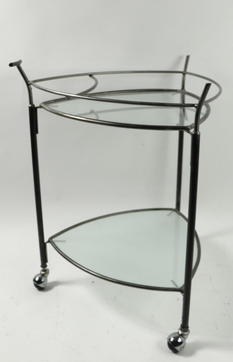 Two-tier bar or serving cart, having two glass shelves, one frosted, one clear, and a iron frame.
Clean, original and ready to use condition.