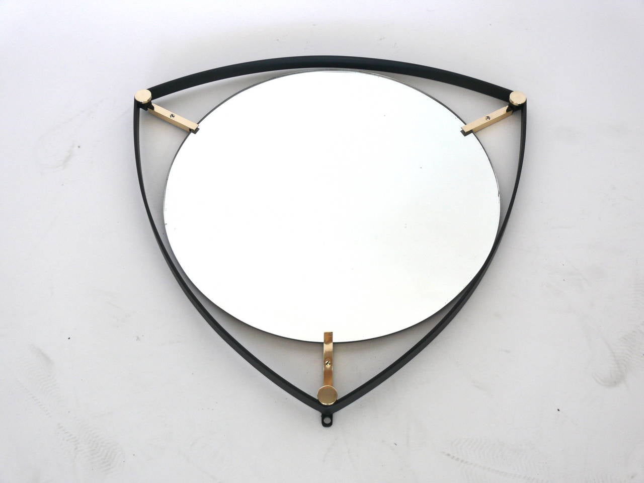 Newly produced Triangular mirror of an Italian design with circular glass floats within an iron frame, suspended by three brass tabs.