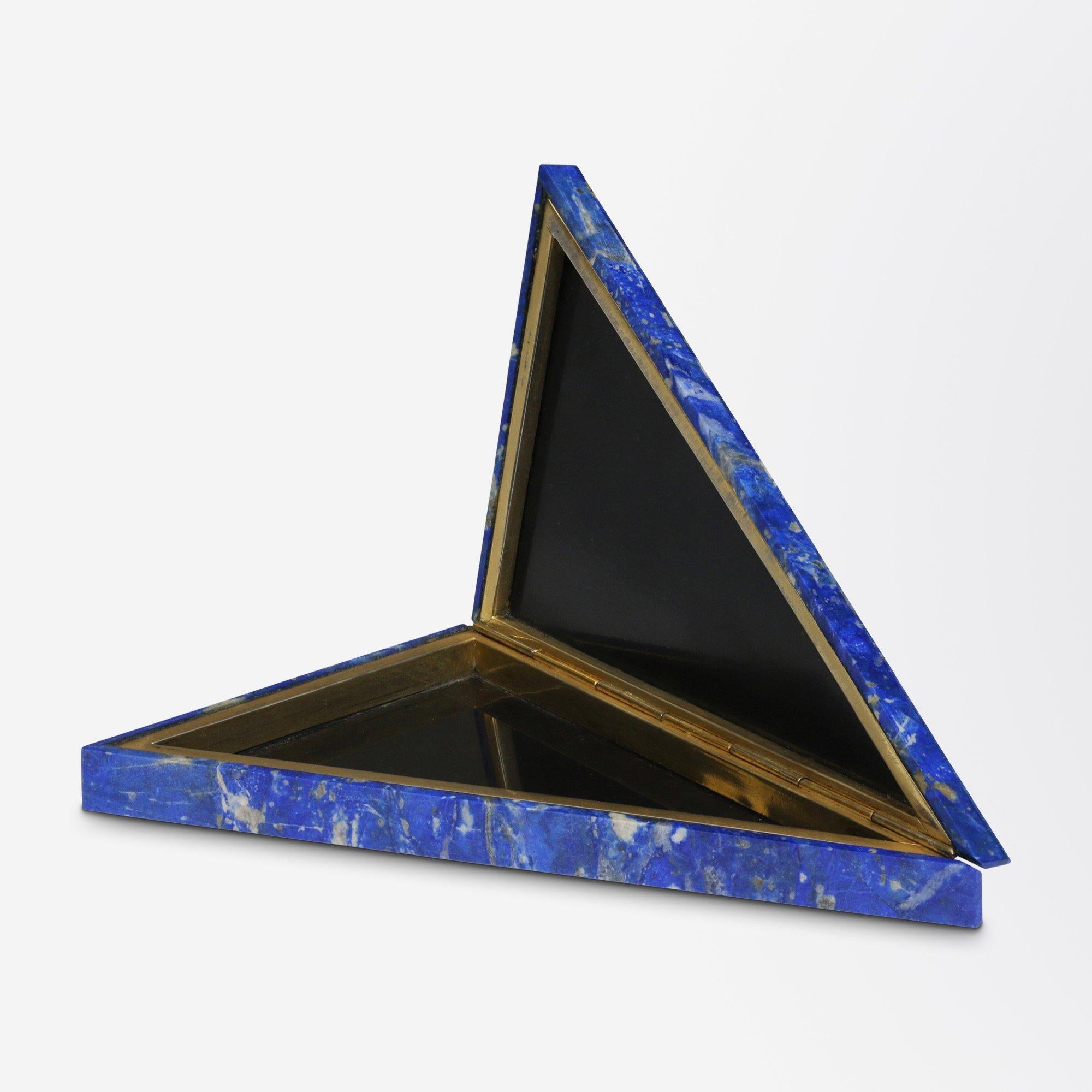 An exceedingly beautiful lapis lazuli specimen box crafted and retailed by 'Pitti Mosaici' in Firenze (Florence). The triangular shaped box is crafted from fine sheets of lapis lazuli and is accented internally with gilt metal hardware. The piece