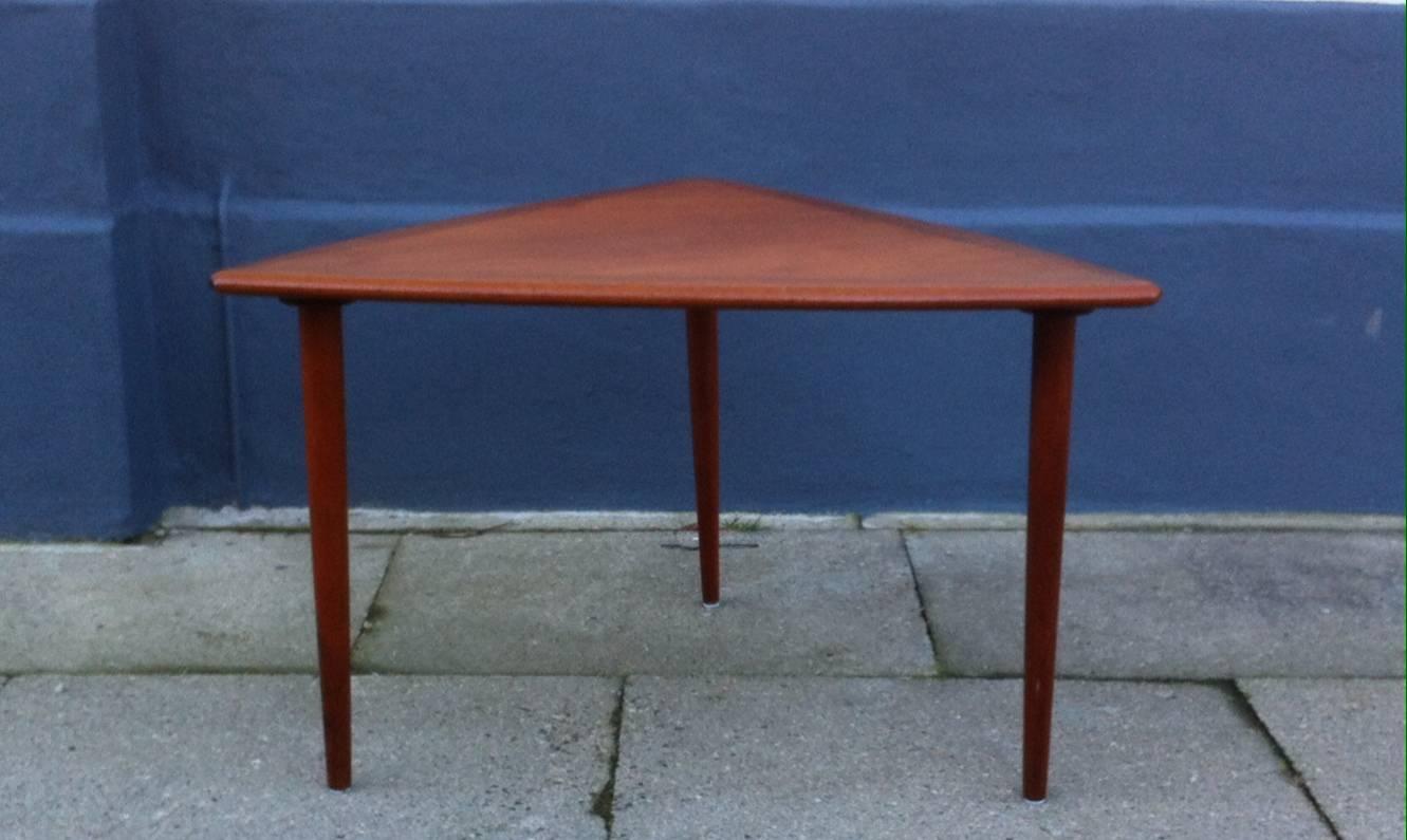 Well made coffee table with solid teak legs and edge in a darker tone. Unidentified maker/designer stamp underneath the table. Measurements: 70 x 70 x 70 cm (28 x 28 x 28 inches), Height: approximate 50 cm (20 inches). This table will be shipped