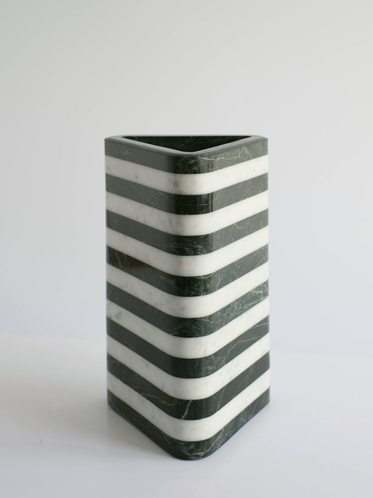 This large triangular green and white marble vessel is a part of the debut collection of Stacked Stone Vessels. This collection marks the beginning of a larger series of sculptural objects exploring the use of lamination, pushing natural materials