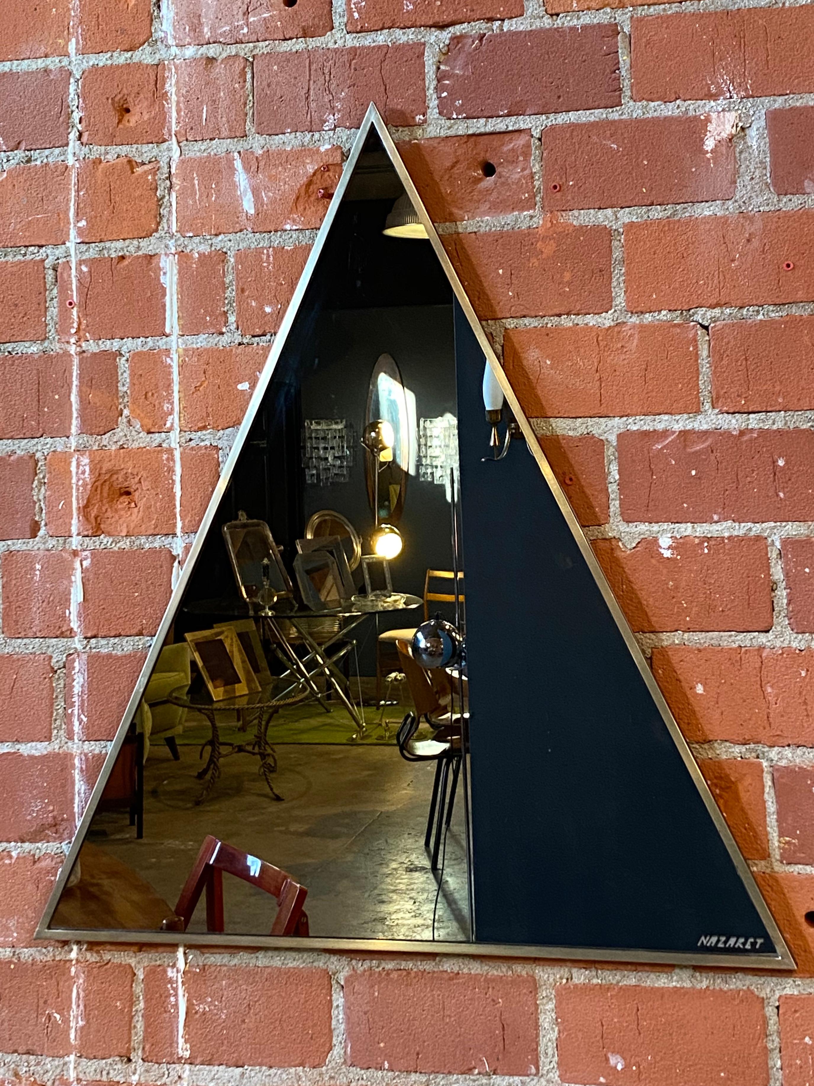 Large triangular steel framed wall mirror, by the Italian designer Romeo Rega for Nazaret, Italy, 1970s.
Rega’s furniture is characterized by geometric shapes and reduced forms.
His designs are almost always gilded, chromed, or brass-plated, which