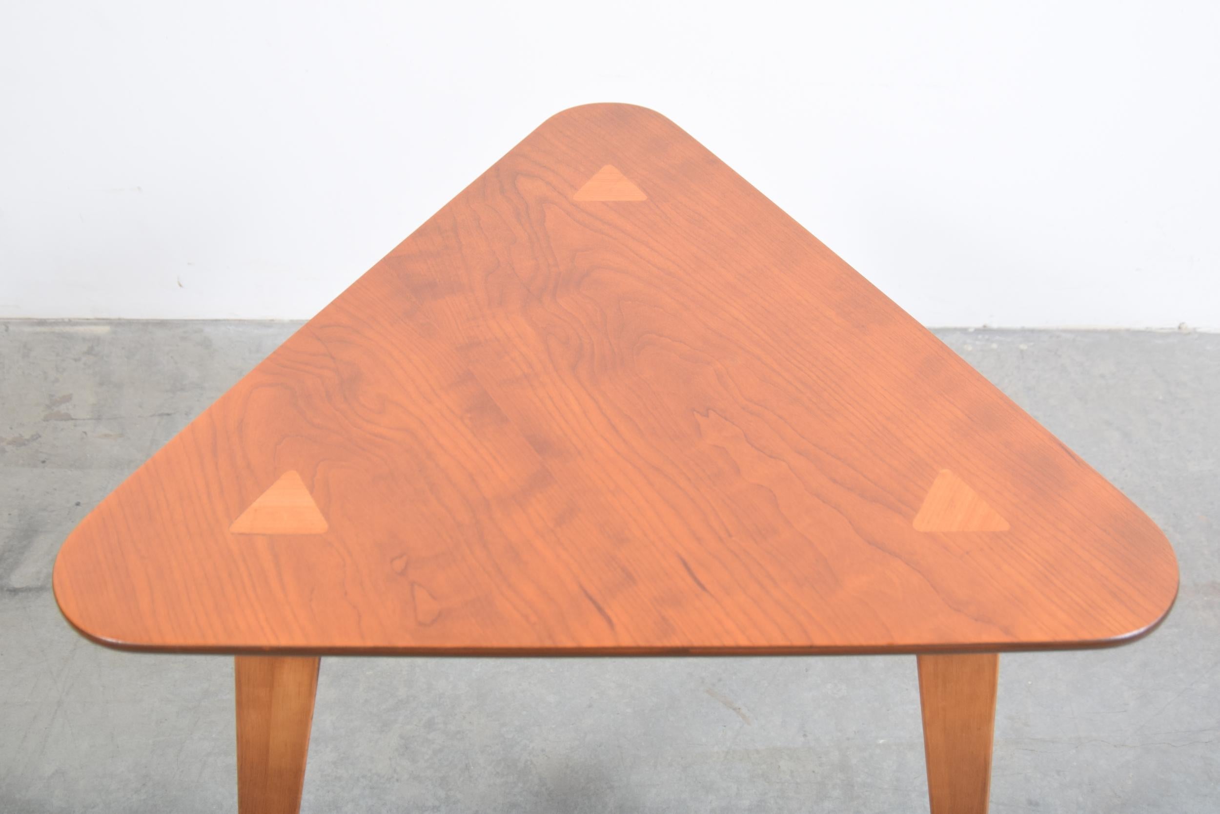 Triangular top lamp table, circa 1955. The top appears to be Japanese Elm, and the legs appears to be Baltic birch. The legs through tenon on the three corners of the top, which is a nice detail. The table measures 25