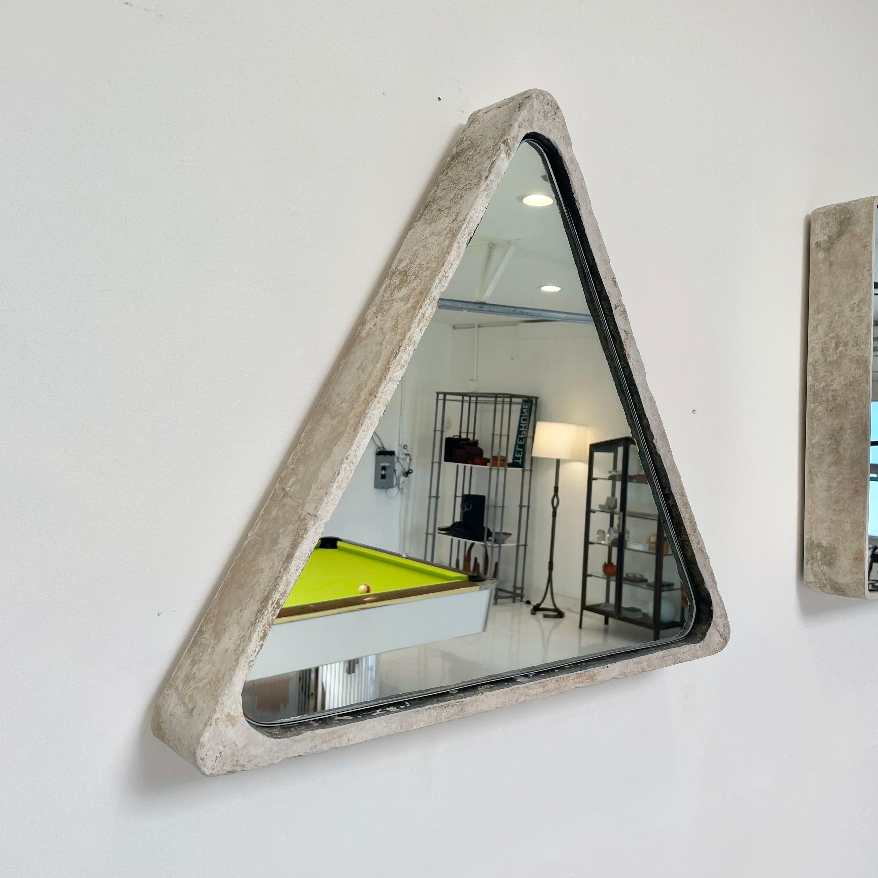 Fabulous triangular Willy Guhl concrete mirror. Concrete vessel originally produced at the Eternit factory in Switzerland in the 1960’s and mirror was professionally hand cut and added recently. Beautiful patina as expected with age featuring myriad