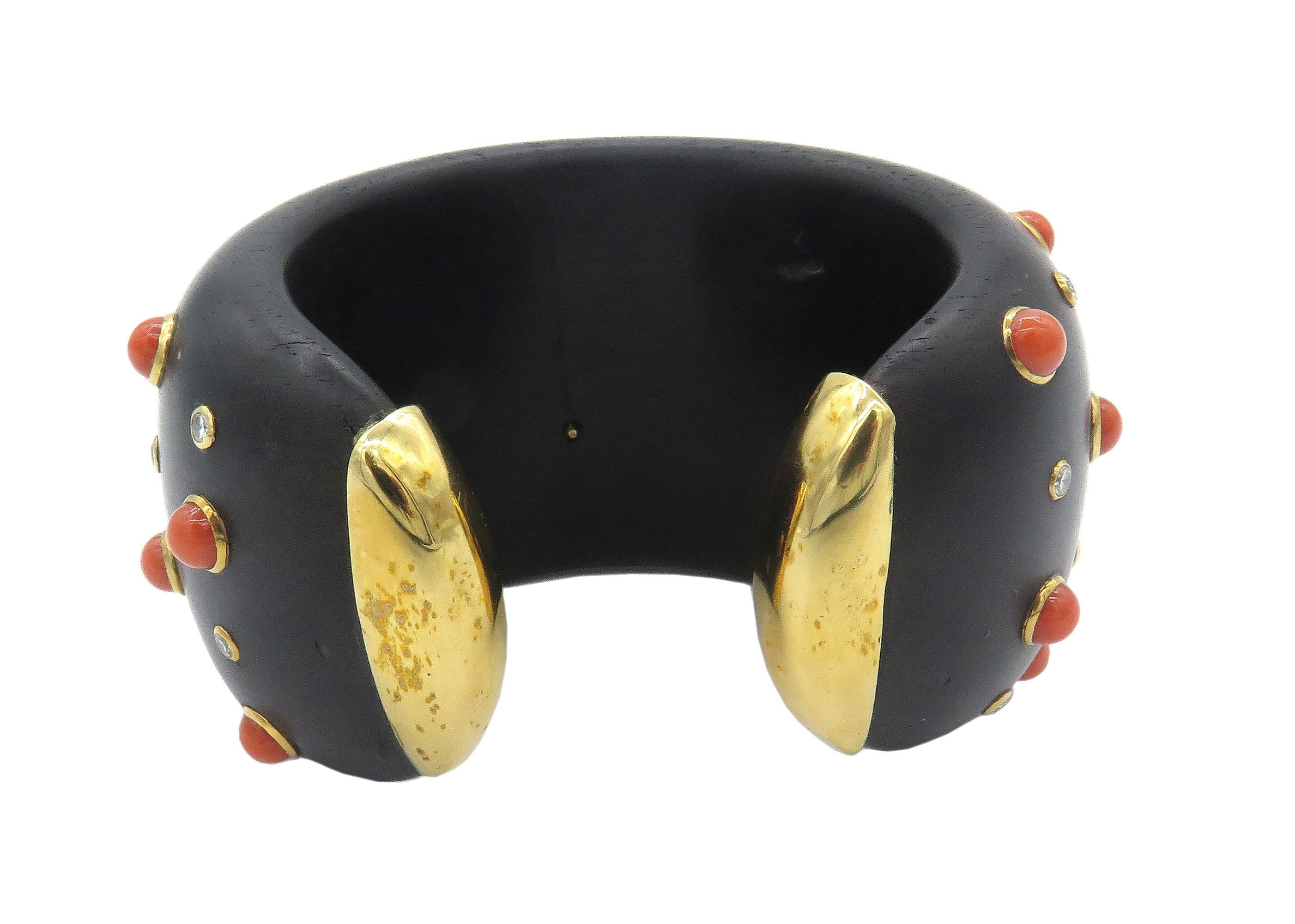 Ebony wood cuff bracelet set with cabochon corals and 18k gold bezels and a beautiful carved 