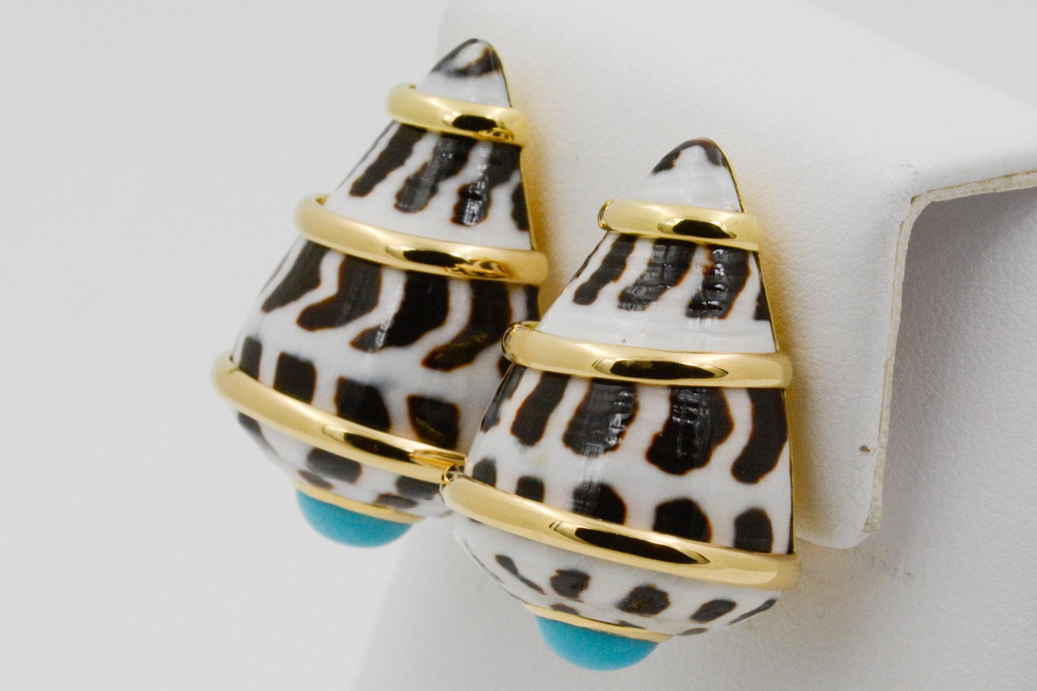 From Trianon, these 18 karat yellow gold Conus Ebraus earrings have a shell design with three yellow gold bands and cabochon turquoise accents with clip backs. Signed Trianon.  

