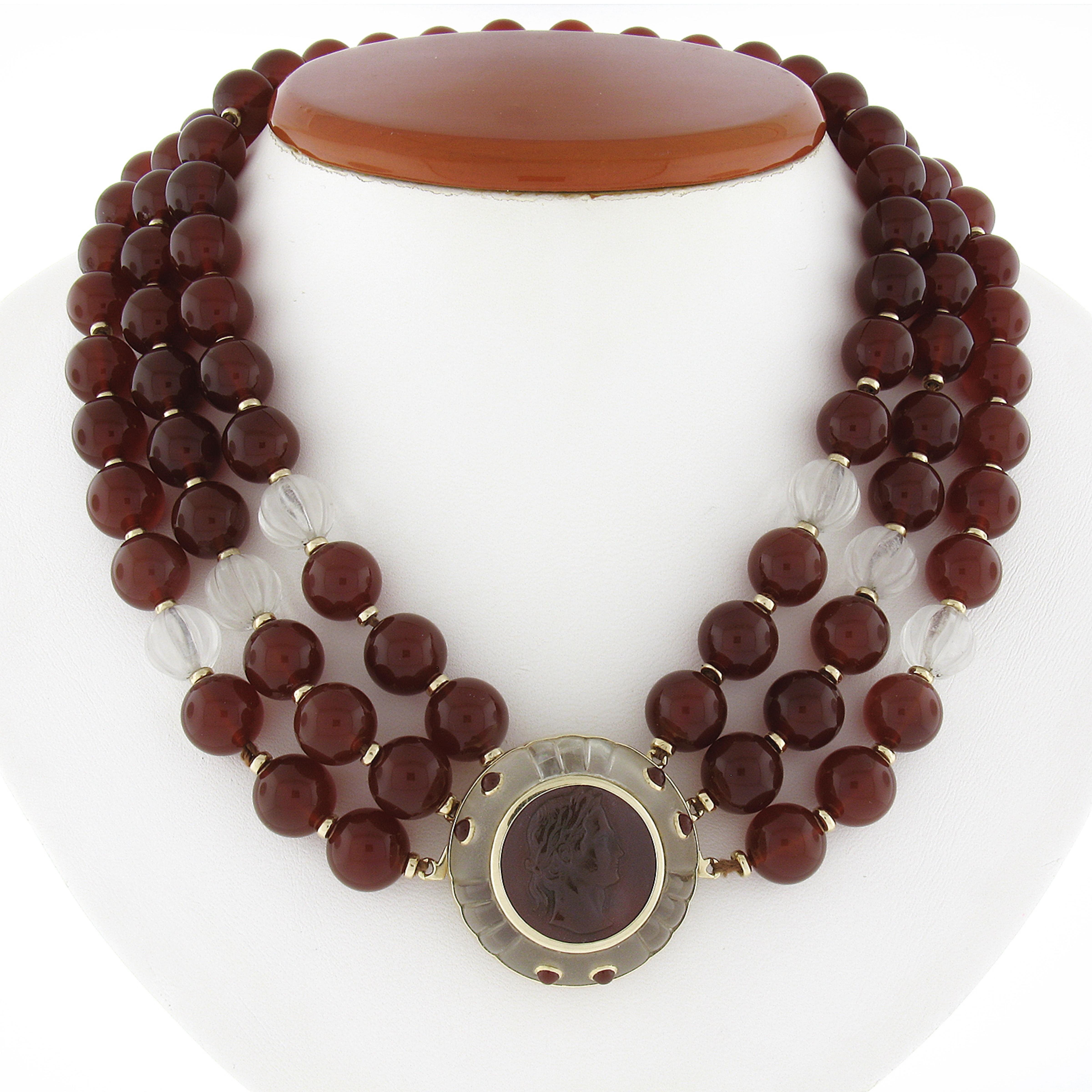 Here we have an absolutely magnificent estate carnelian and rock crystal bead 3 strand necklace that features an incredible cameo carved carnelian pendant set in solid 14k yellow gold with a grooved rock crystal frame. The carnelian on this pendant