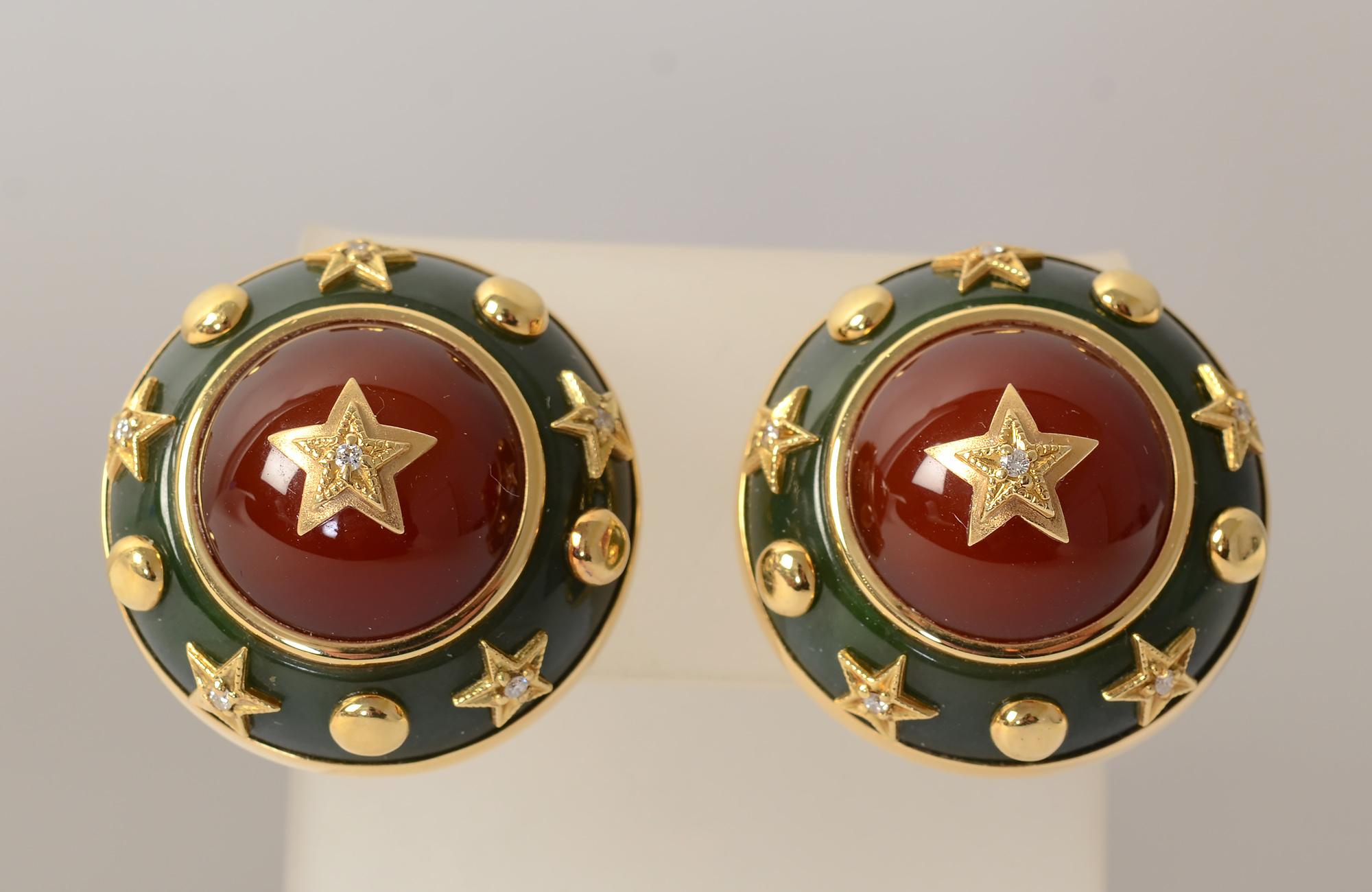 Sporty and sophisticated domed earrings by Trianon. A gold star with a diamond is in the middle of a cabochon carnelian. It is surrounded by a band of aventurine that alternates the same stars with gold dots. The earrings are 1 1/4 inches in