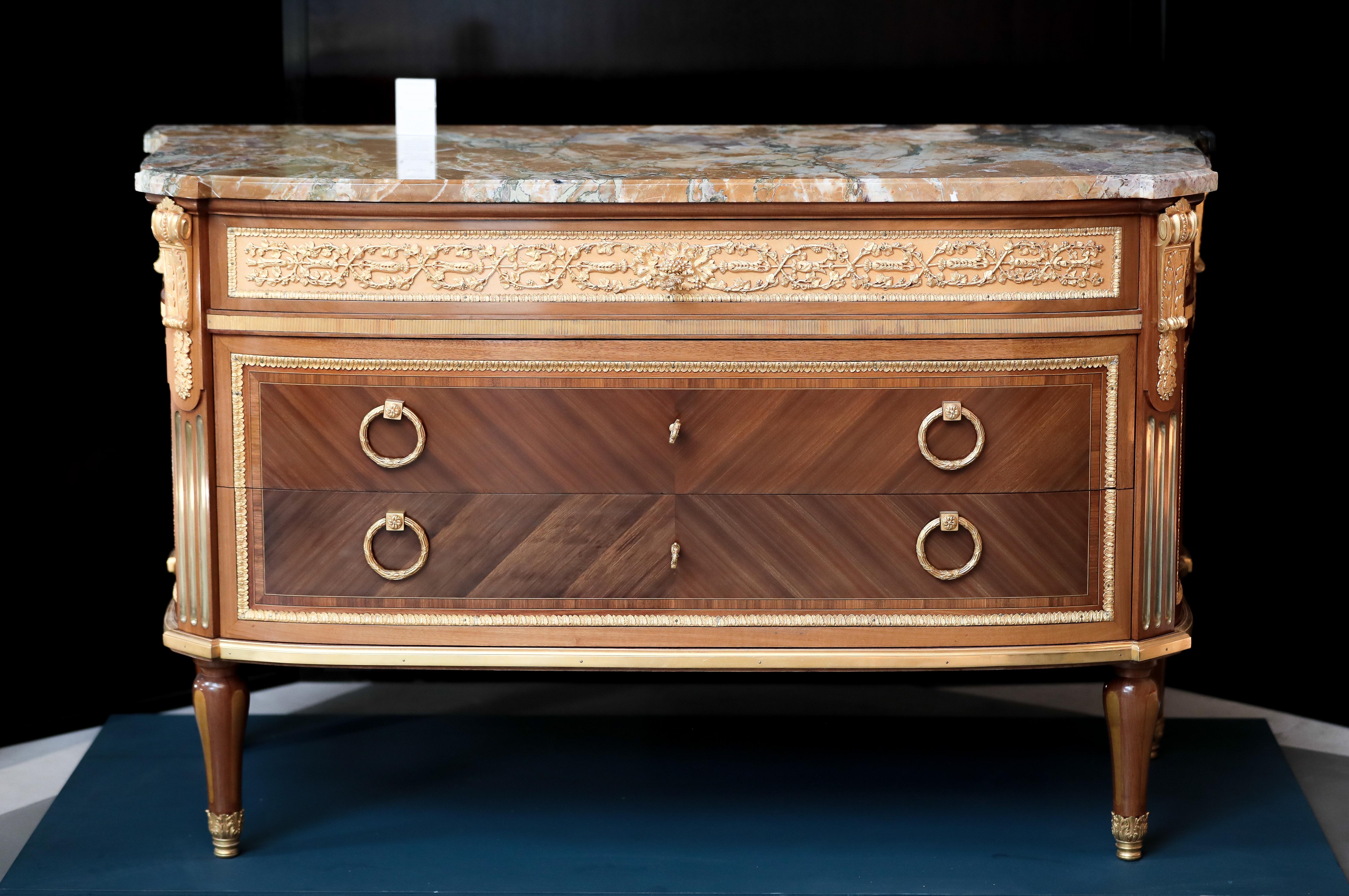The Trianon chest of drawers is a replica by Rinck of a piece created by Jean Francois Leleu for Marie Antoinette.

Details:

Marble-top
Kingwood and mahogany veneer
Chased gilt bronze ornaments
Varnish finishing.


