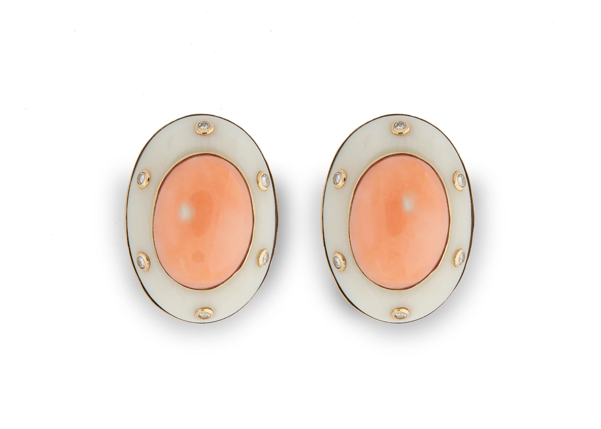 Trianon the sister company to Seaman Schepps frames beautiful pinkish orange coral with pure white coral and adds a touch of diamonds to create a chic wearable earring. 1 inch in size.