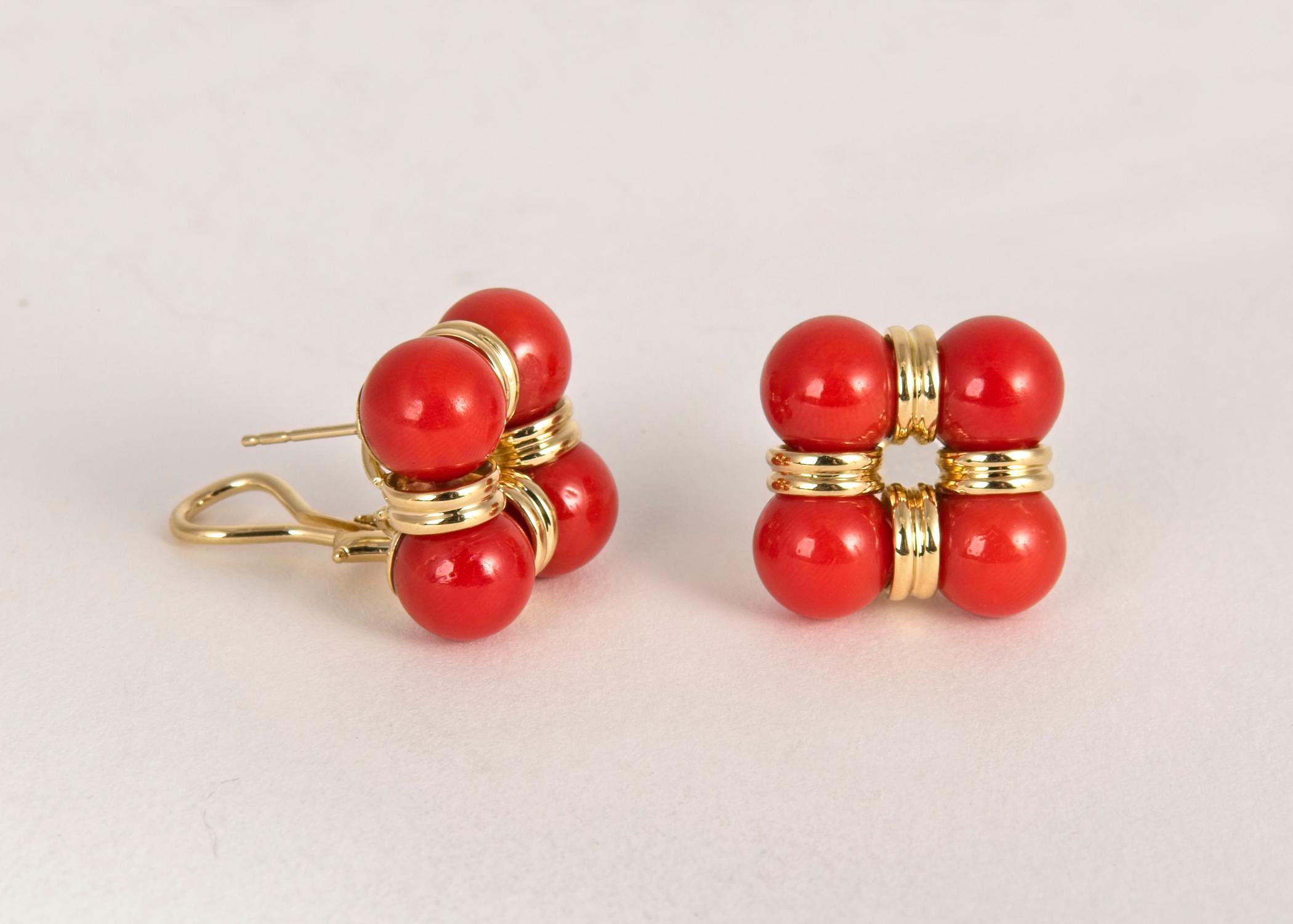 Trianon, the sister company of Seaman Schepps features vivid orange coral and rich 18k gold in this tailored elegant earring. 3/4's of an inch in size.