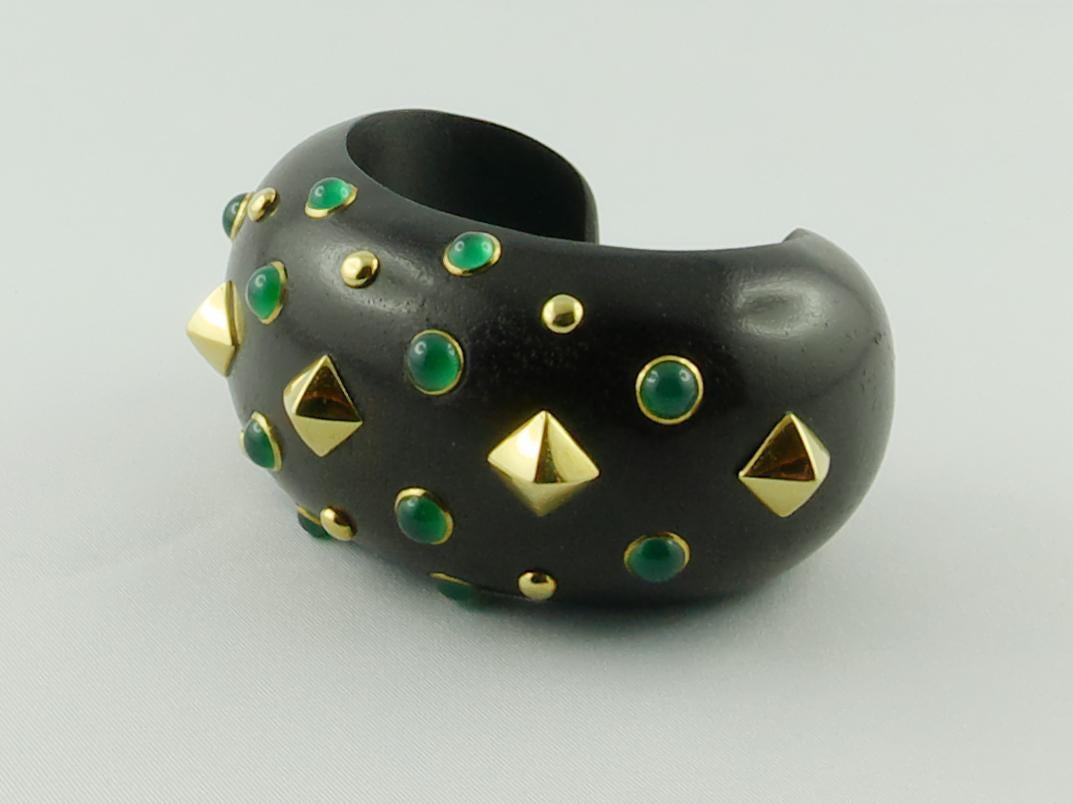 Stunning Trianon smooth Ebony wood cuff bracelet, accented by cabochon-cut  Chrysoprase set in 18k yellow Gold mounts, and yellow Gold studs that give a bold and glamourous look.  Creating original jewels with unusual combinations of precious and