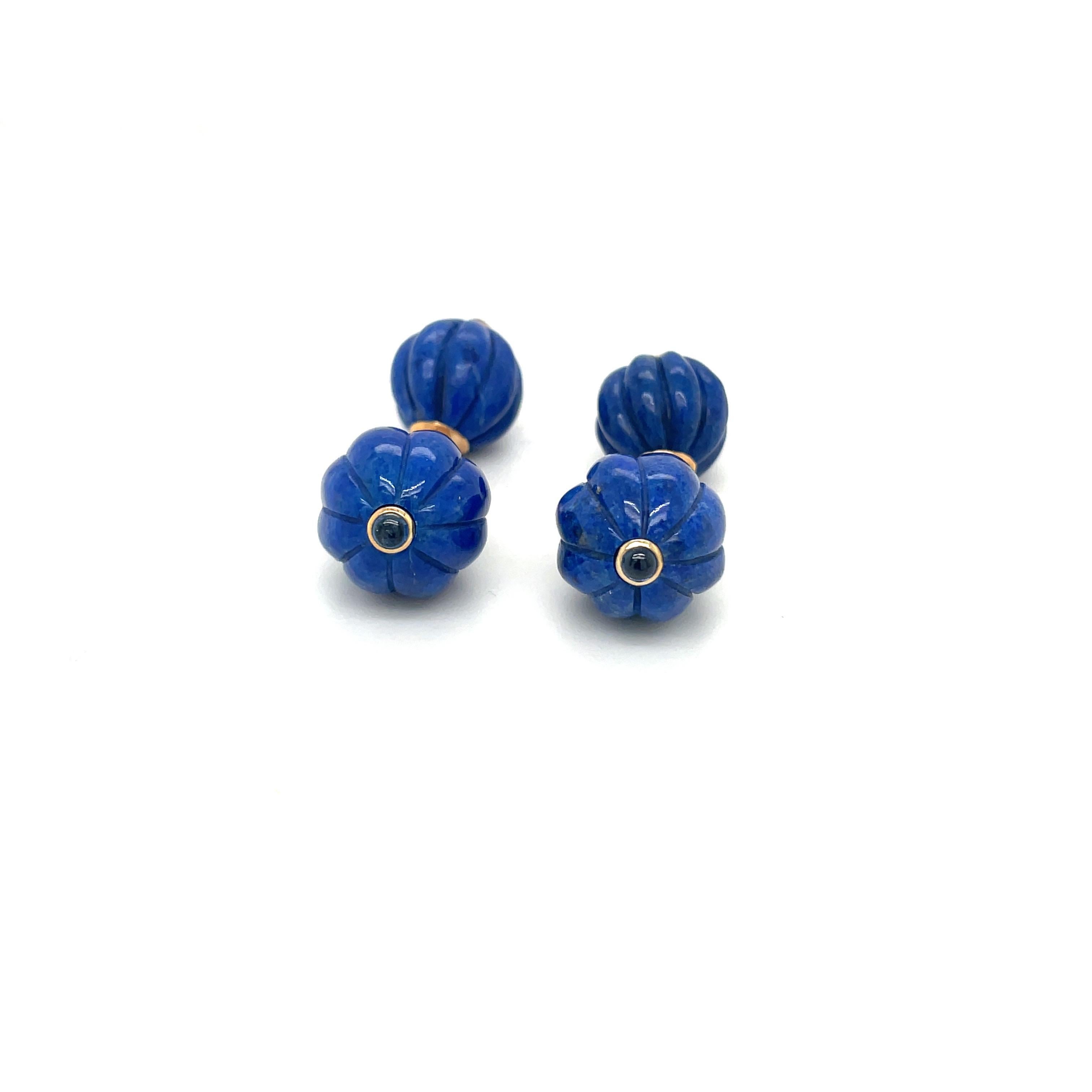 Beautiful polished  Lapis Lazuli  fluted bead cuff links. Each center is set with a blue sapphire cabochon. The stones are held together with a 14 karat gold link chain.
Stamped Trianon 14k