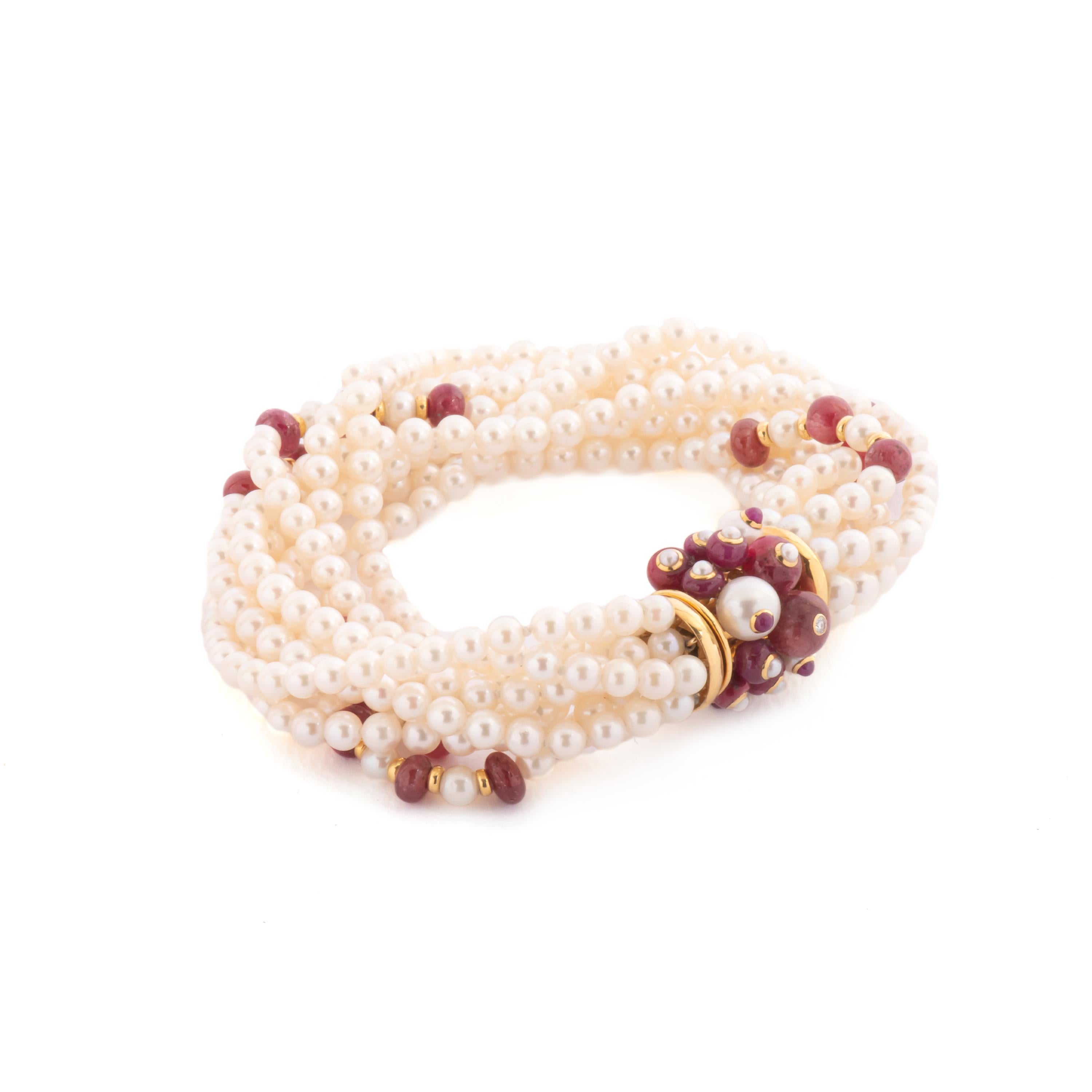 Trianon multi strand bracelet, crafted with japanese pearls and rubies. 18k yellow gold clasp with pearls ball, also decorated with ruby cabochons and diamonds. Bracelet   Marked Trianon, 