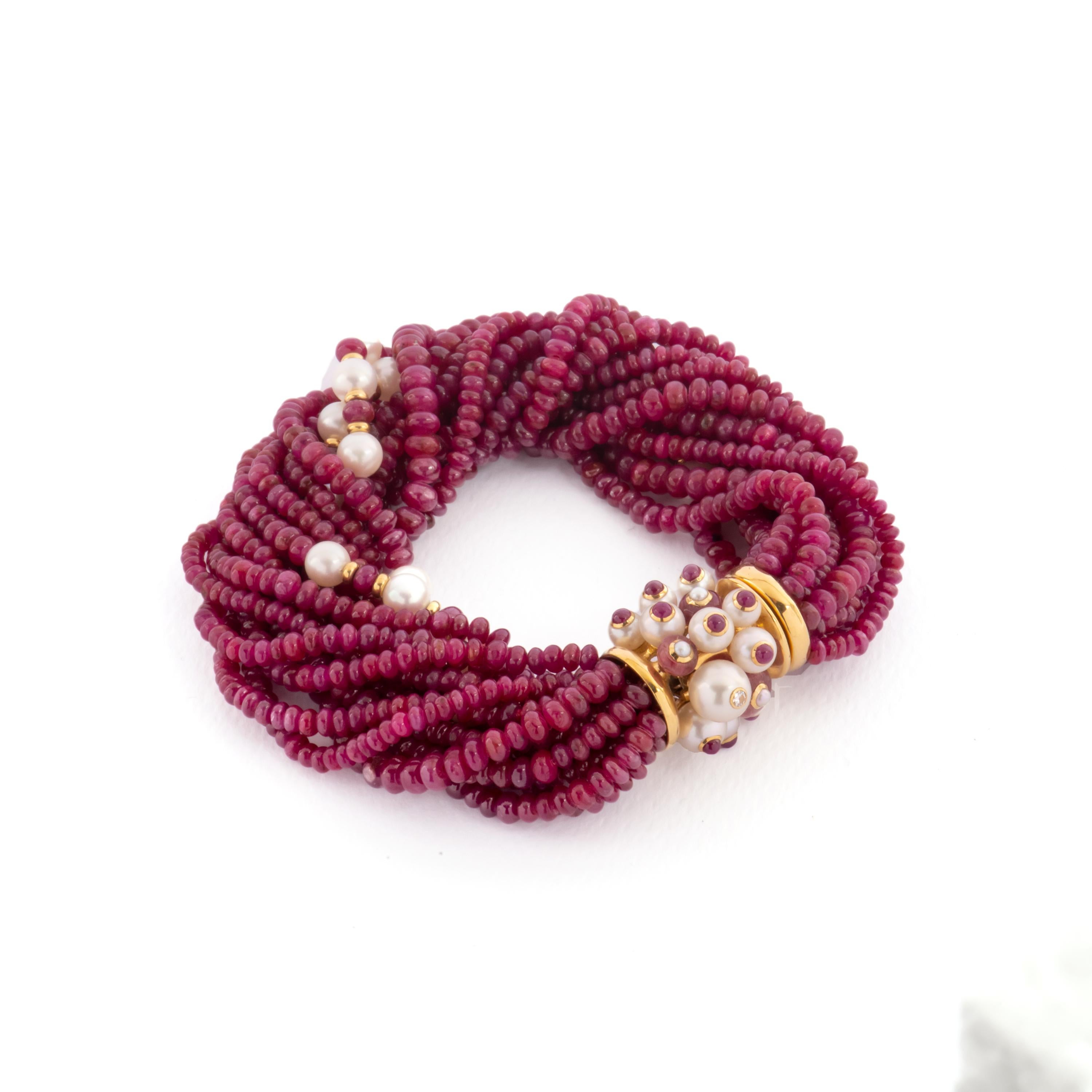 Trianon multi strand bracelet, crafted withrubies. 18k yellow gold clasp with pearls ball, also decorated with ruby cabochons and diamonds. Bracelet   Marked Trianon, 