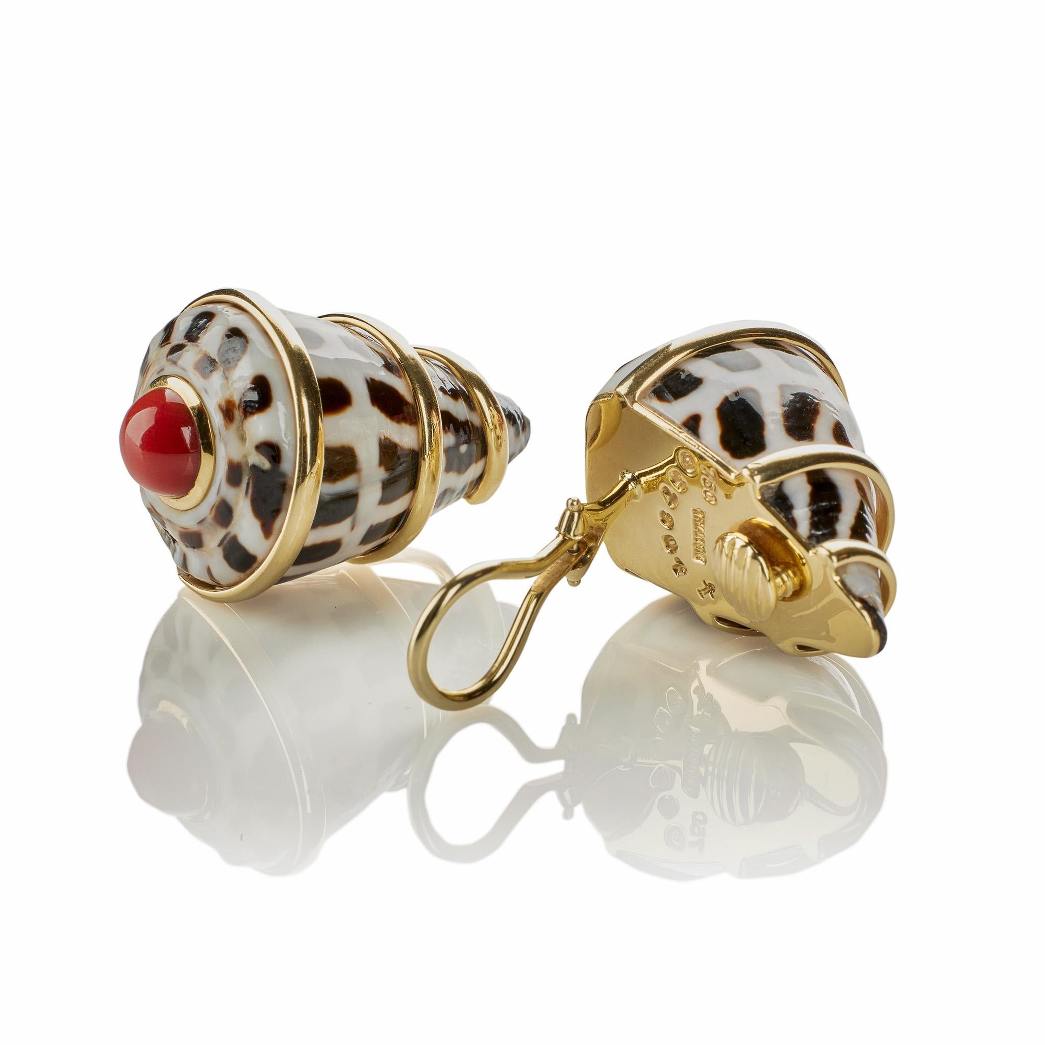 Of late 20th century design, these Trianon black and white patterned shell earrings with coral are set in 18K gold. Reversed so that the conical ends point upward, each Conus Ebraus shell is wrapped in three strands of 18K gold and highlighted by an